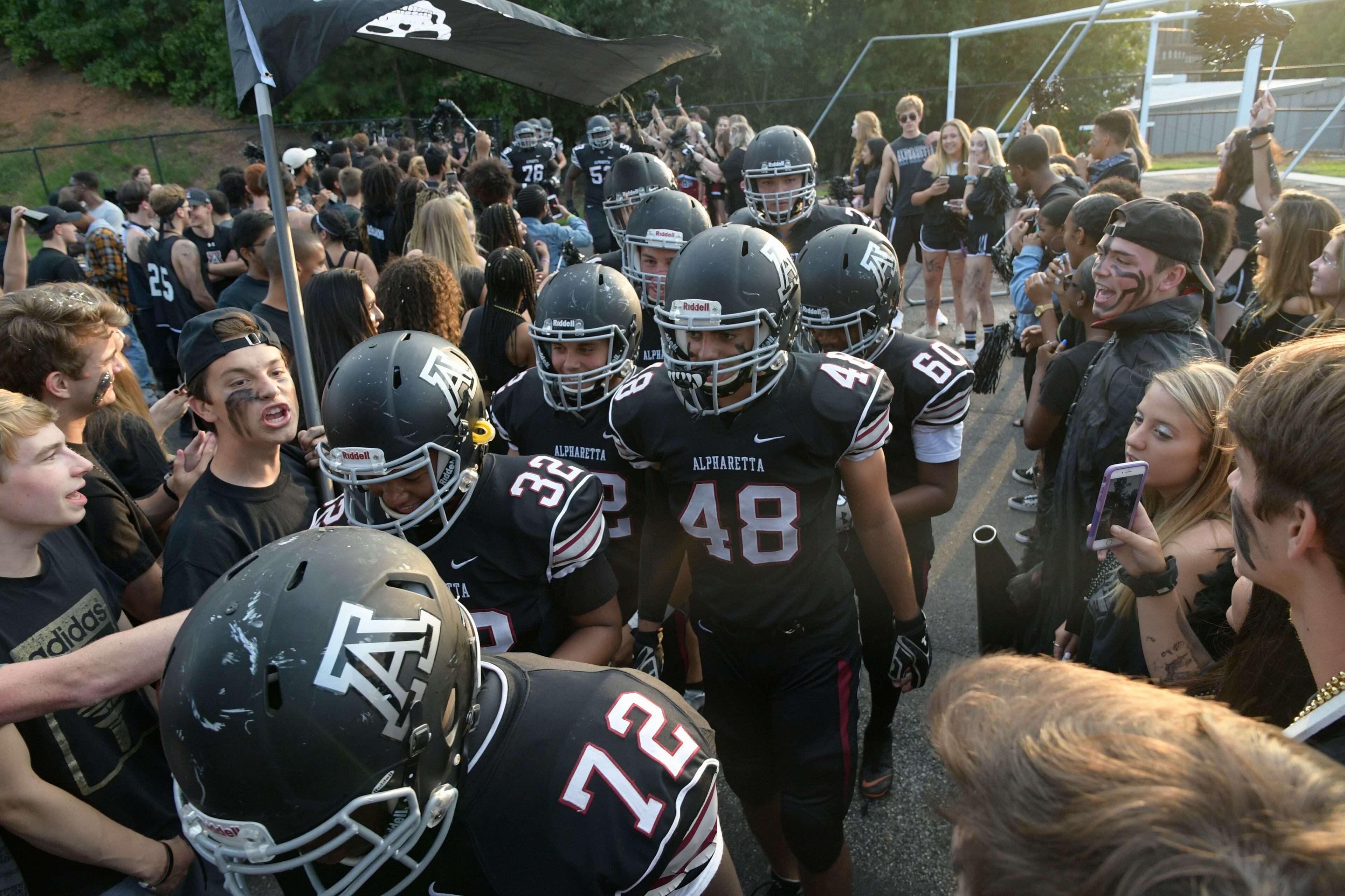 Alpharetta High School football team arrives for a high school football game against Milton on Friday, Aug. 24, 2018. (John Amis/Special_