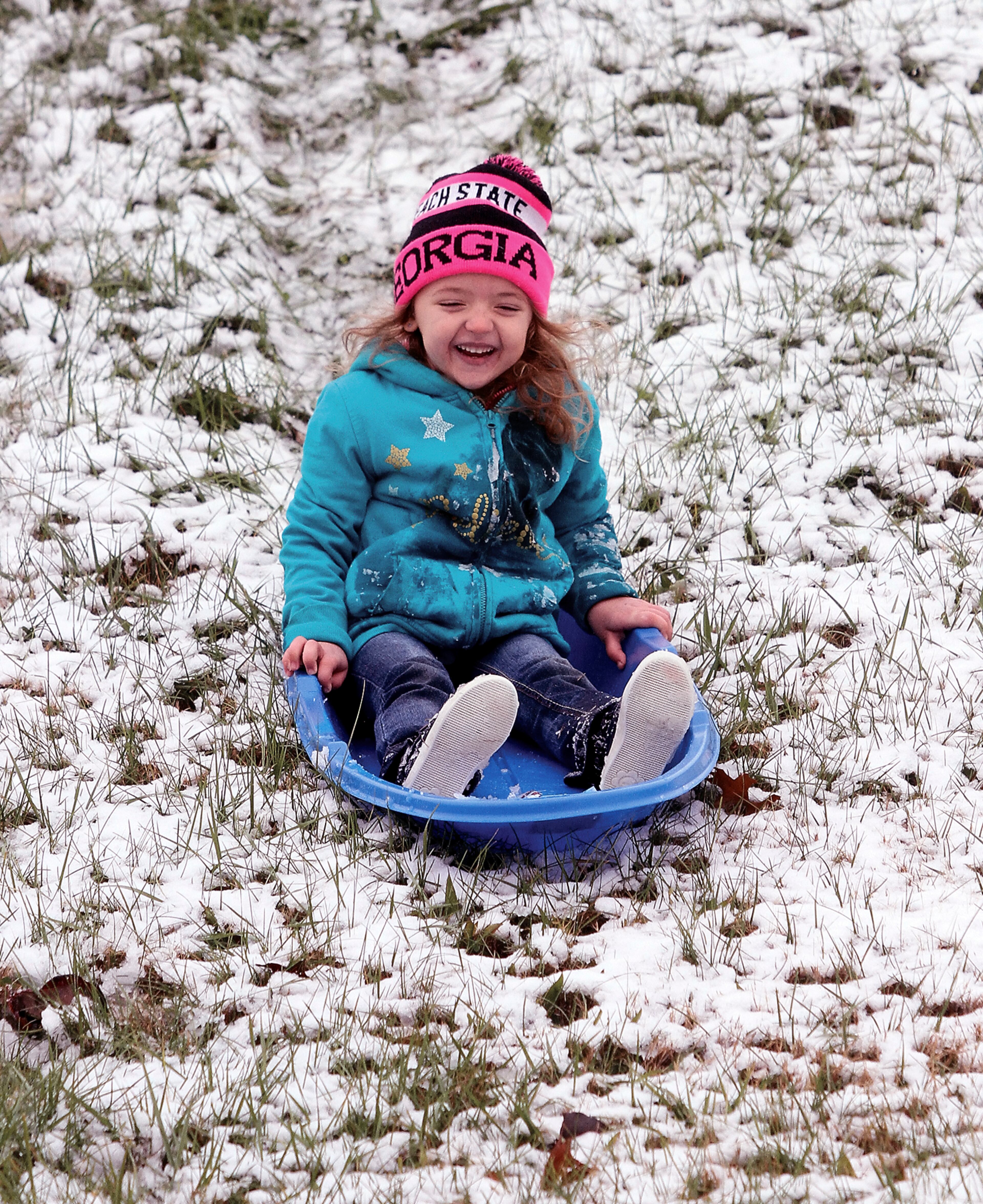 Katrina Pickle enjoys sledding after the first snow of the season in Blount County at Foothiils Mall in Maryville, Tenn., Sunday, Dec. 9, 2018. (Tom Sherlin/The Daily Times via AP)