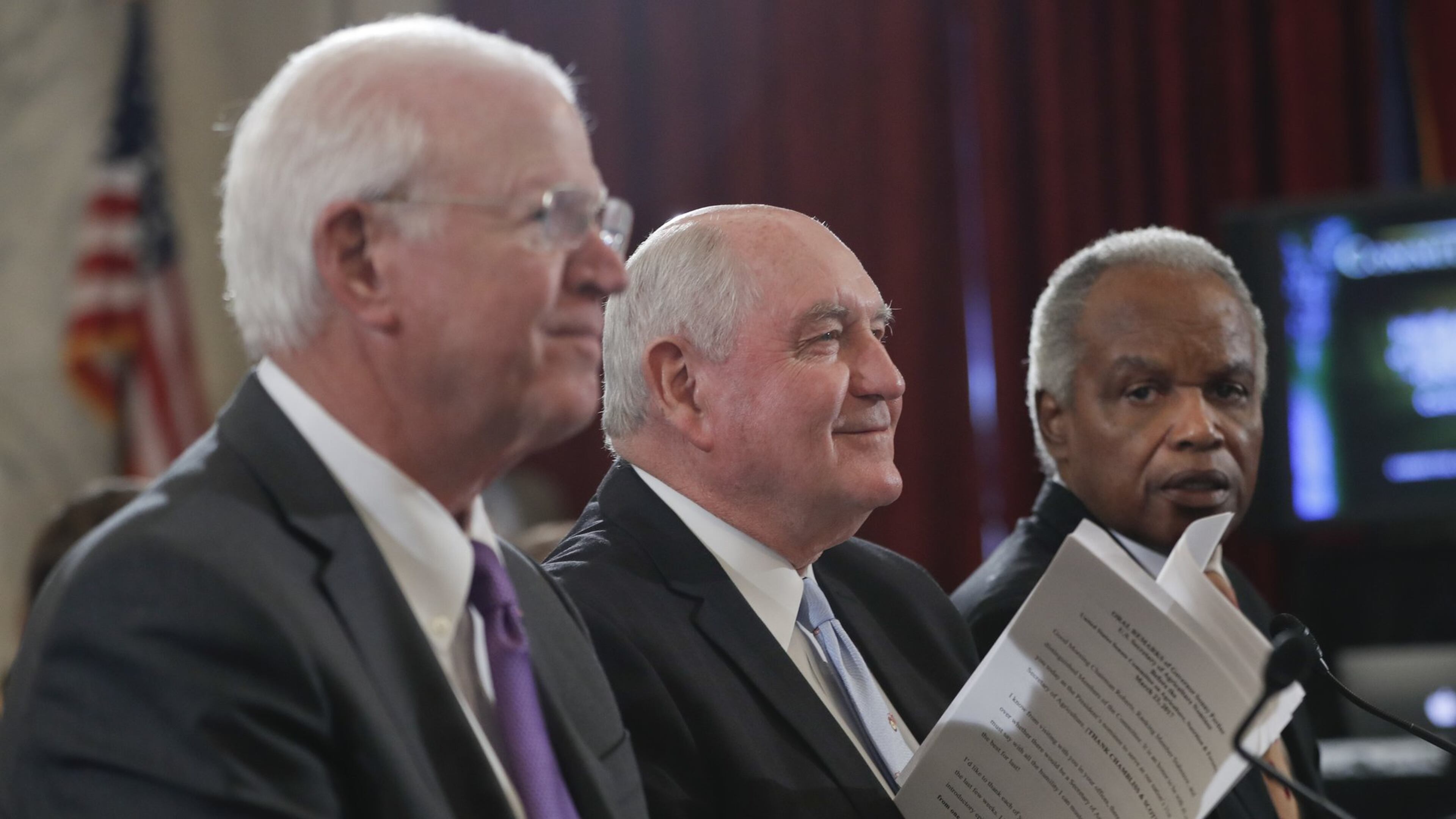 Former Georgia Gov. Sonny Perdue, center, prepares to testify Thursday during his confirmation hearing to become secretary of agriculture. He is accompanied by former Georgia U.S. Sen. Saxby Chambliss, left, and U.S. Rep. David Scott, D-Atlanta. (AP Photo/Pablo Martinez Monsivais)