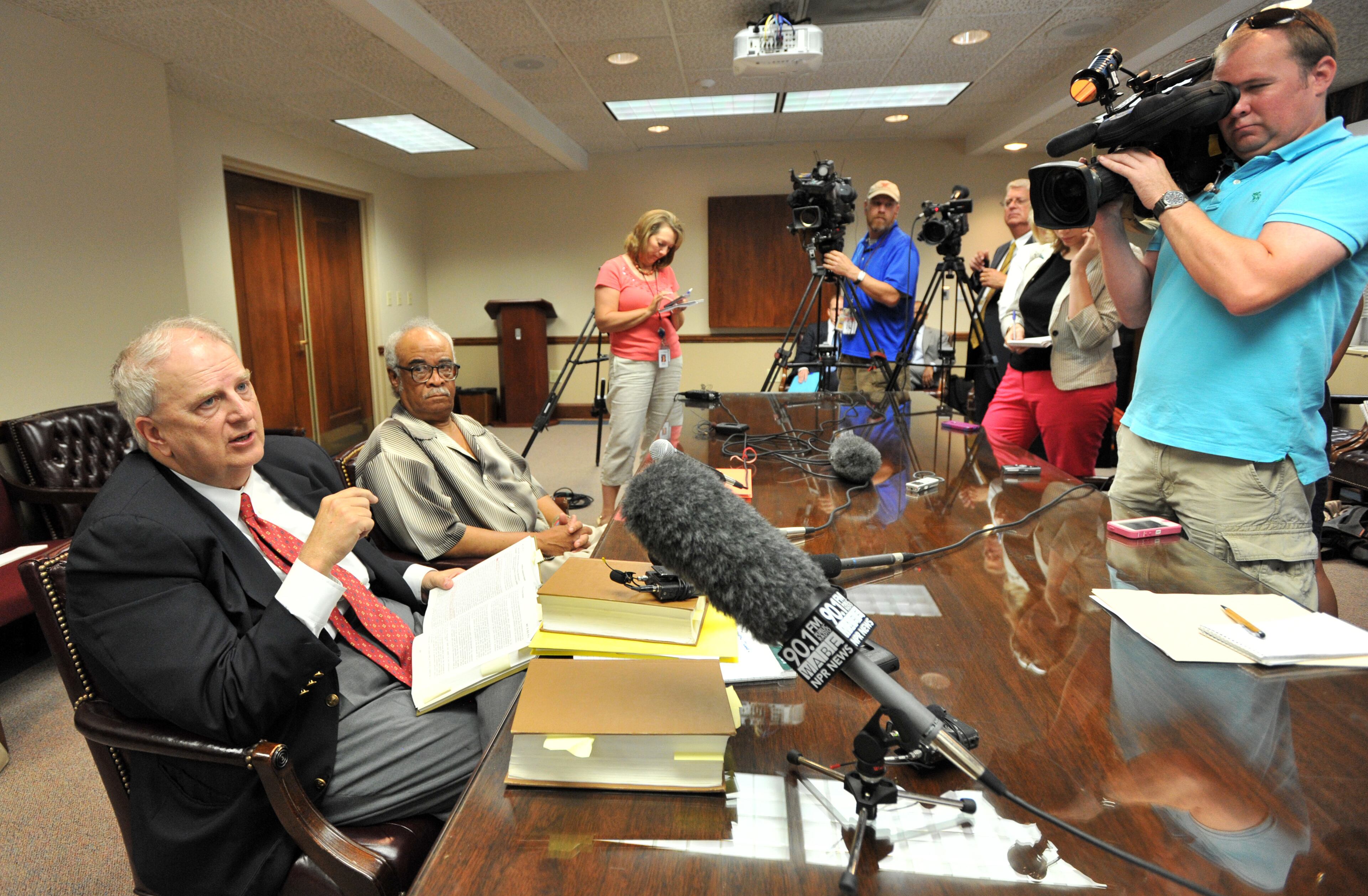 Former Gov. Roy Barnes (left) speaks to members of press as Rep. Tyrone Brooks (second from left) looks after the hearing on Friday, June 28, 2013. Brooks, D-Atlanta, faces 30 federal charges of wire, tax and mail fraud related to his work with a pair of charities. The U.S. Attorney's office alleges that Brooks used contributions meant for those charities for his personal expenses.