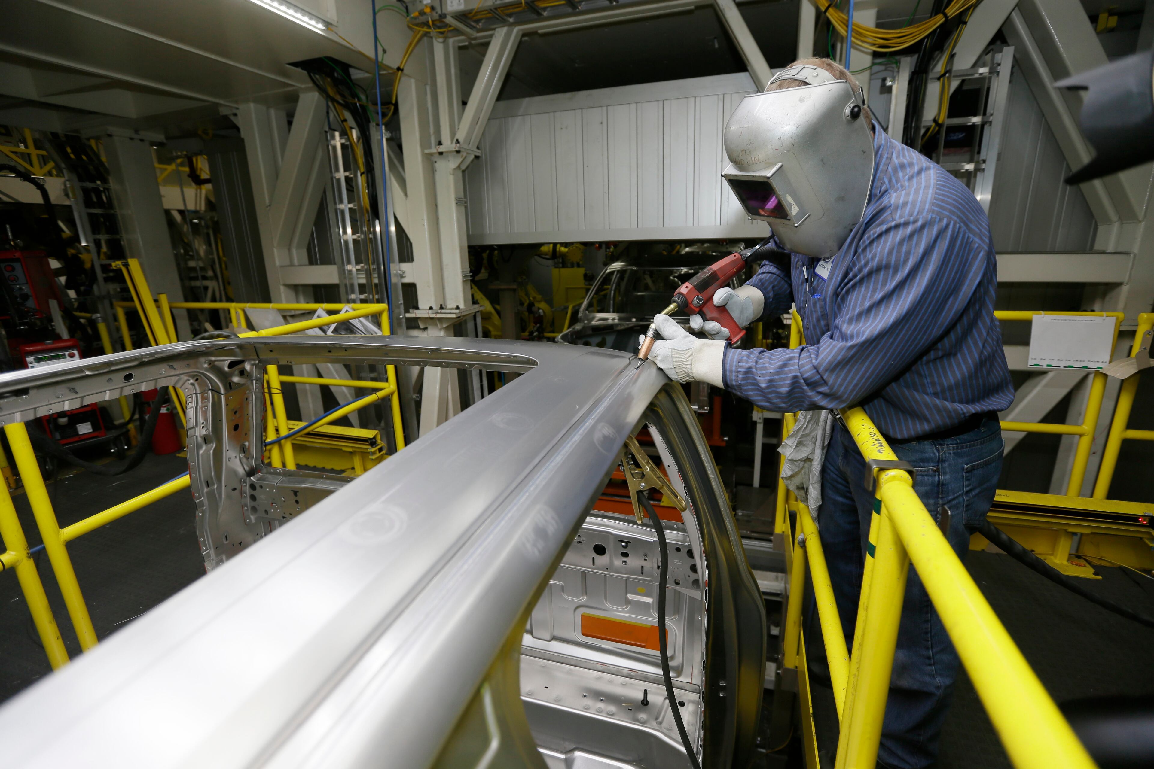 Ron Hudgin works on the new Ford F-150 truck at the Rouge Truck Plant in Dearborn, Mich.It's the automaker's biggest bet in decades: an aluminum-sided F-150 that could set a new industry standard _ or cost the company its pickup truck crown. It will arrive on U.S. dealer lots next month. Aluminum _ which is lighter than steel but just as strong _ isn't new to the auto industry, but this is the first time it will cover the entire body of such a high-volume vehicle. (AP Photo/Carlos Osorio)