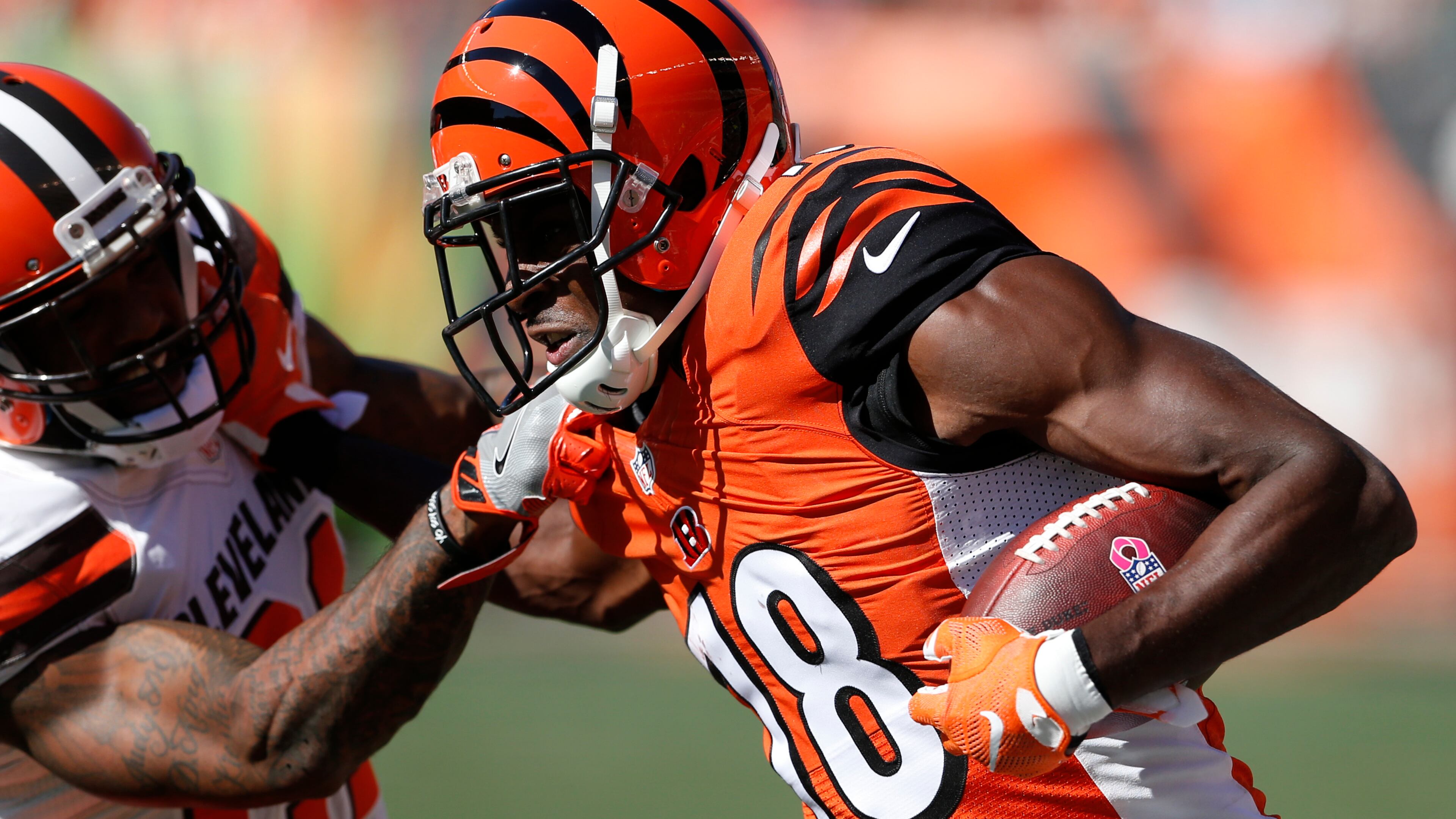 In this Oct. 23, 2016, file photo, Cincinnati Bengals wide receiver A.J. Green (18) runs against Cleveland Browns cornerback Jamar Taylor, left, in the first half of an NFL football game in Cincinnati. Green leads the NFL with 59 catches and is second with 896 yards receiving. (AP Photo/Gary Landers, File)