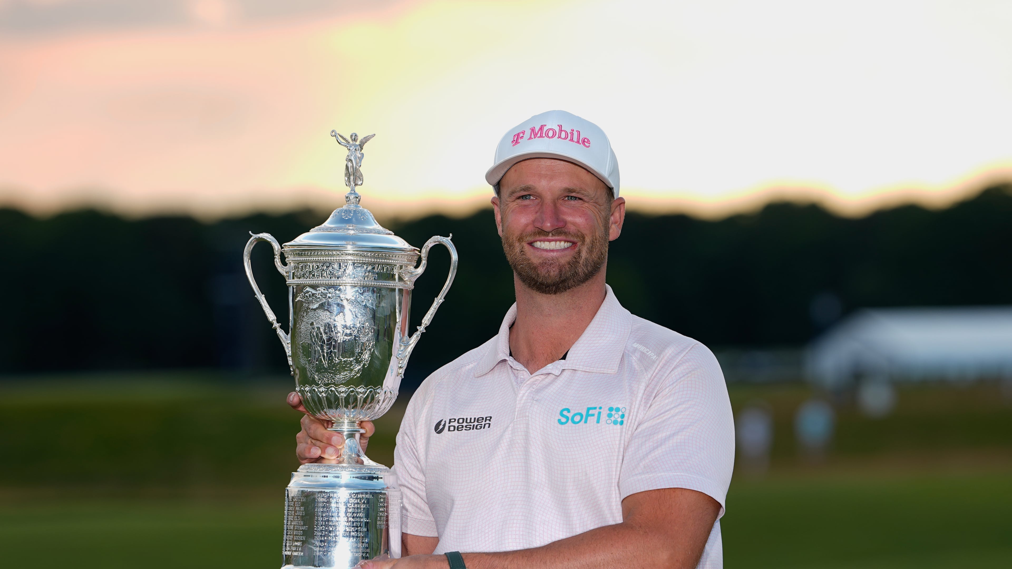 Wyndham Clark holds the trophy after winning the U.S. Open golf tournament at Shinnecock Hills Golf Club in Southampton, N.Y., Sunday, June 21, 2026. (AP Photo/Gerald Herbert)