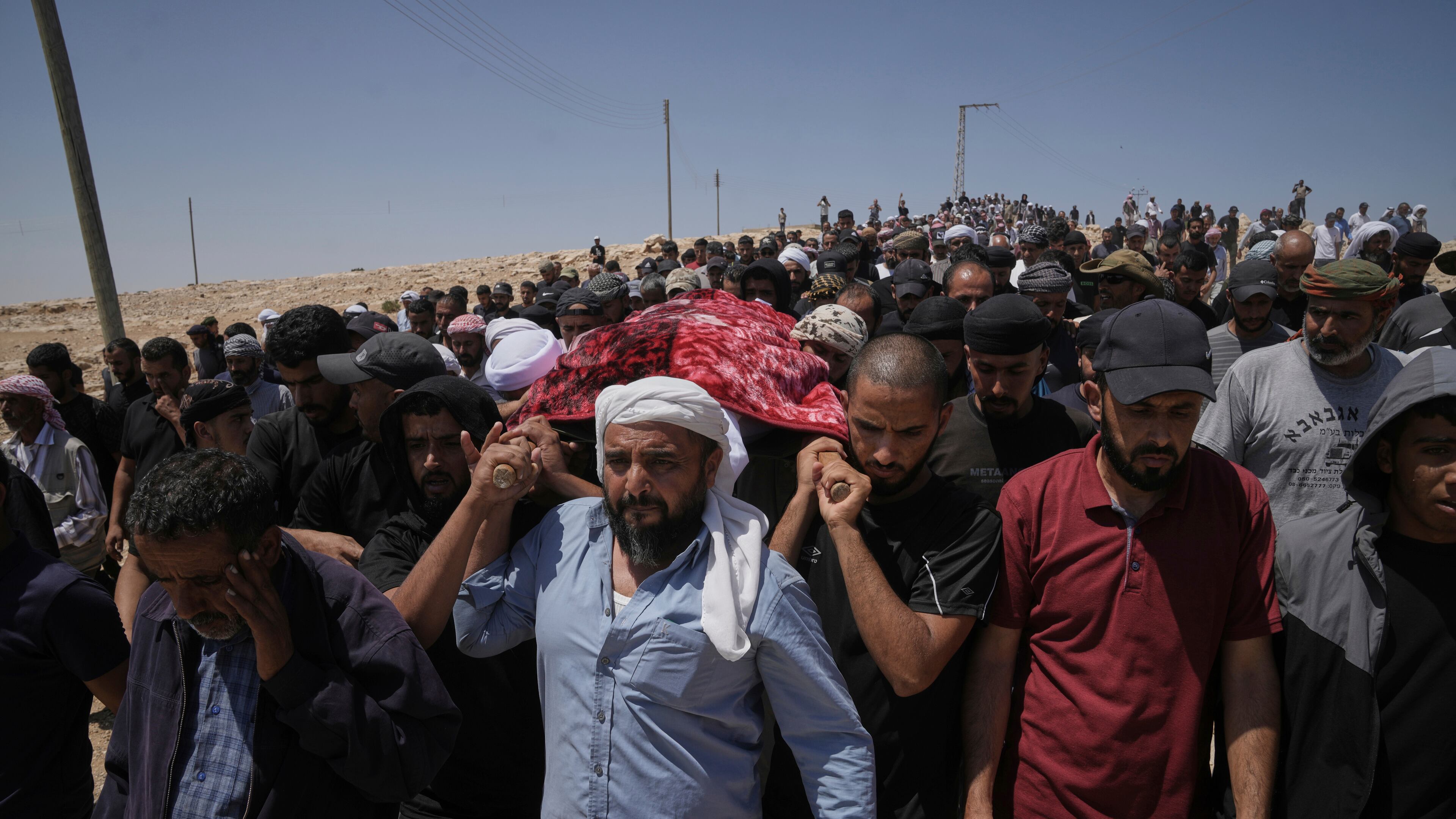 FILE - Mourners carry the body of Palestinian activist Awdah Hathaleen during his funeral in the West Bank Bedouin village of Umm al-Khair, Aug. 7, 2025. (AP Photo/Mahmoud Illean, file)