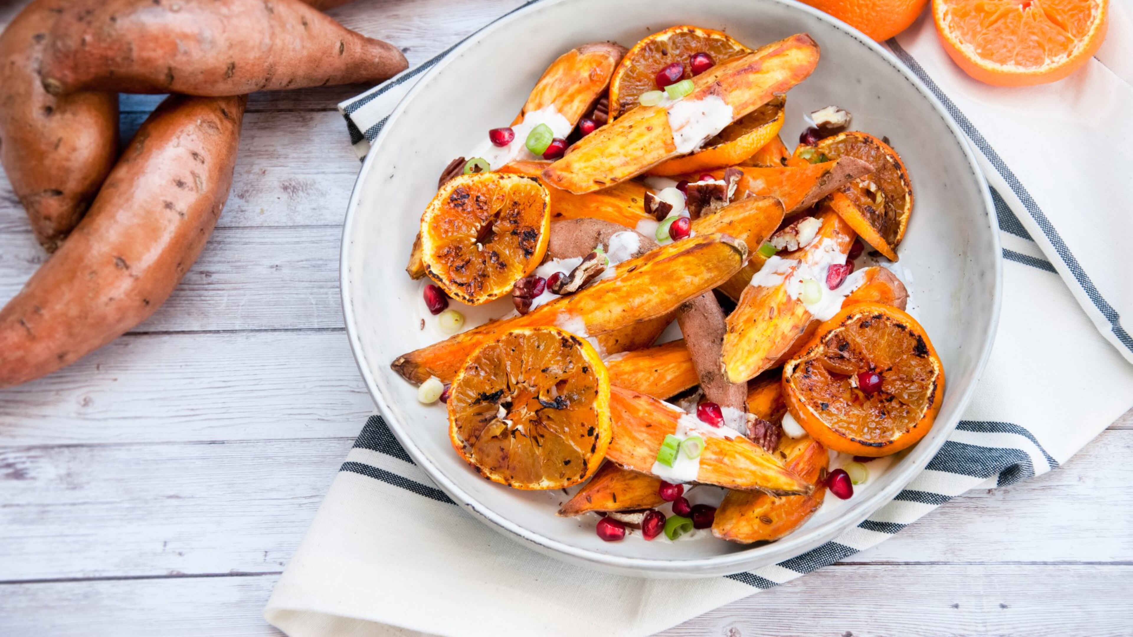 A dish such as spiced sweet potatoes with charred satsumas, pecans and pomegranate yogurt dressing celebrates the bounty of Georgia’s late fall and early winter crops. CONTRIBUTED BY OLIVIA RADER FOR GEORGIA GROWN