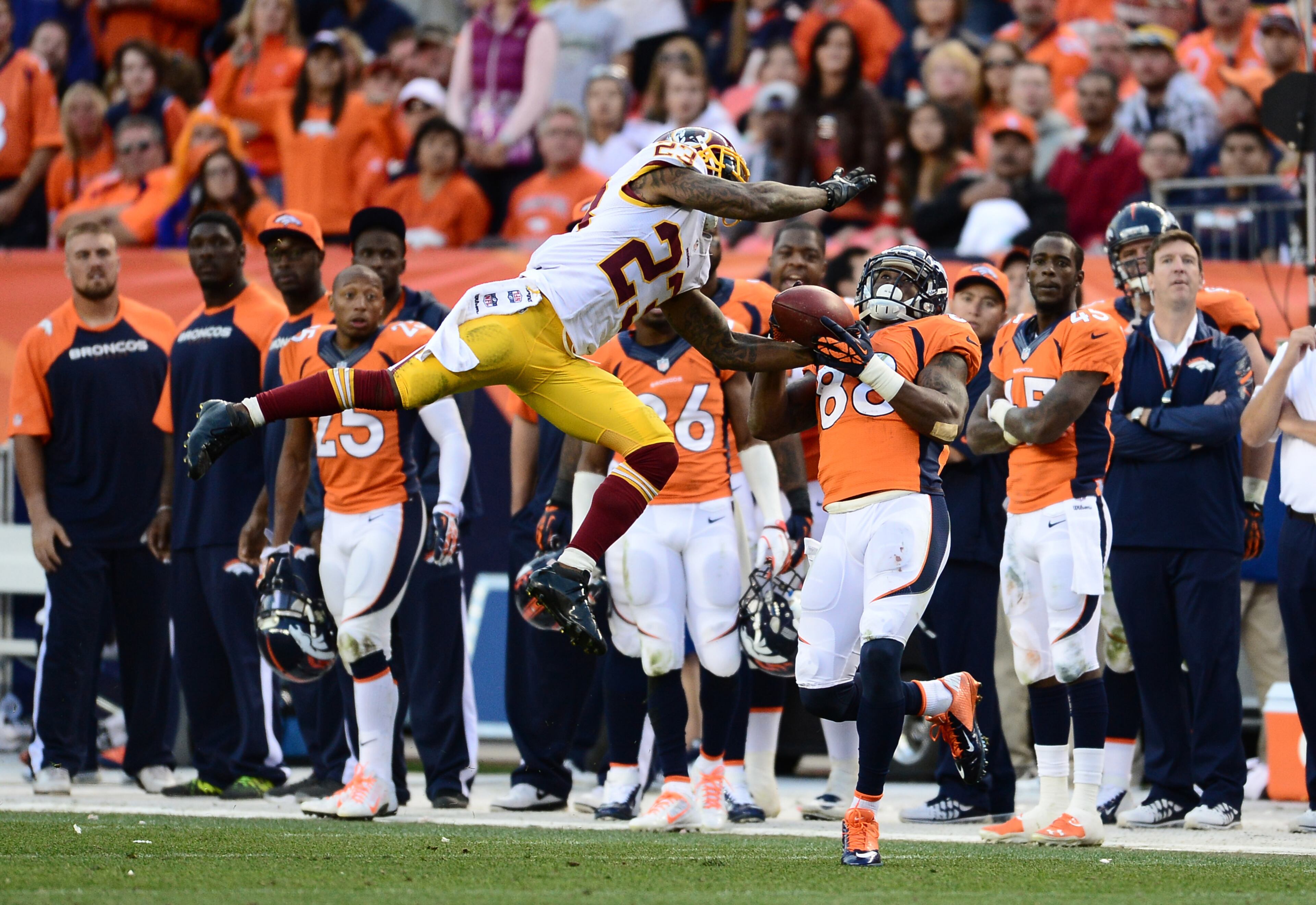 Washington Redskins cornerback DeAngelo Hall (23) intercepts a pass intended for Denver Broncos wide receiver Demaryius Thomas (88) in the fourth quarter at Sports Authority Field at Mile High. The Denver Broncos beat the Washington Redskins 45-21. Mandatory Credit: Ron Chenoy-USA TODAY Sports