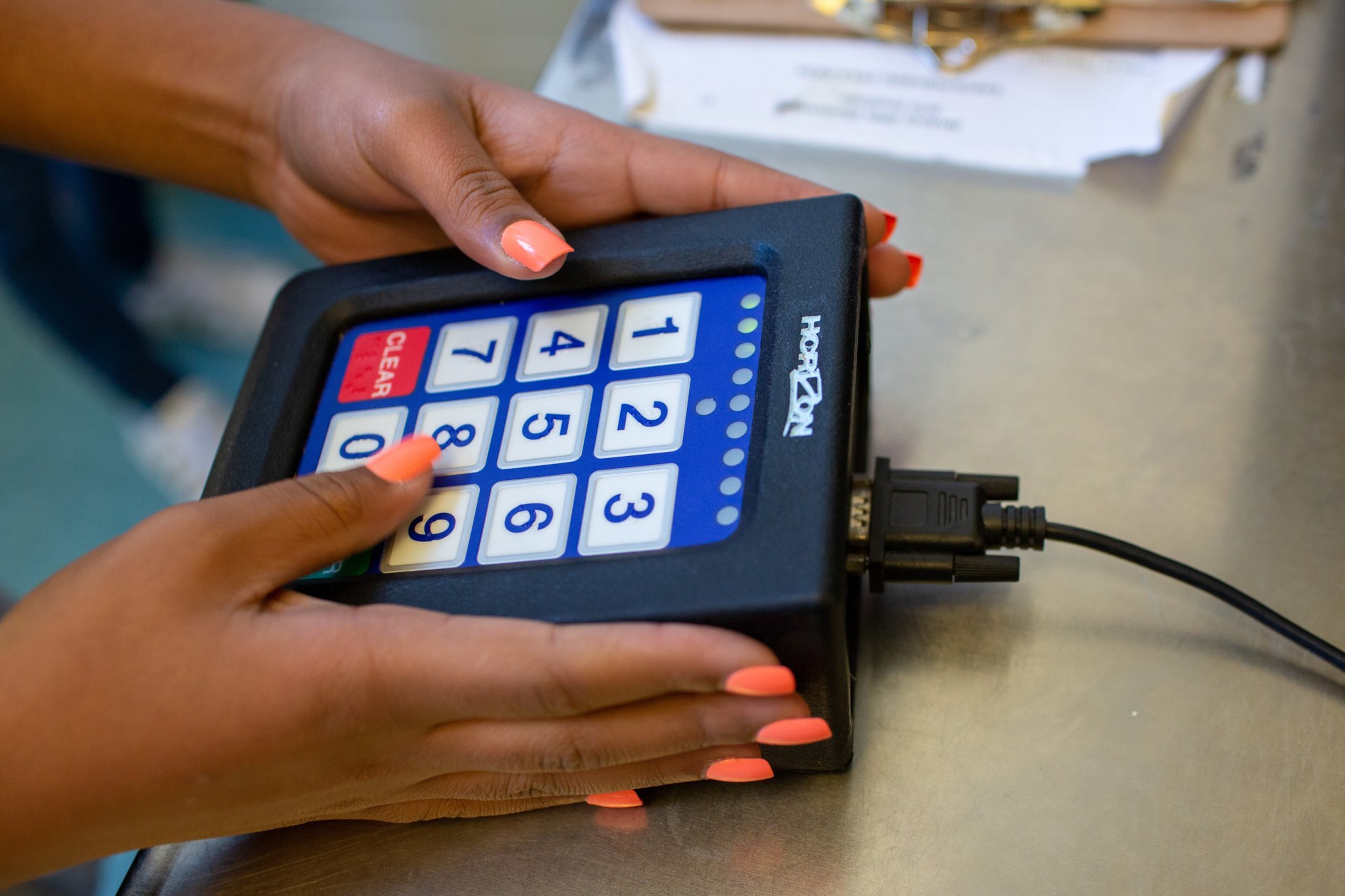 A student punches in their student ID before getting lunch at Hickory Hills Elementary School in Marietta, Georgia, enjoy their lunch on Tuesday, Jan. 21, 2020. Many children in Georgia still cannot afford the standard lunch and either accrue lunch debt or are fed an alternate meal.