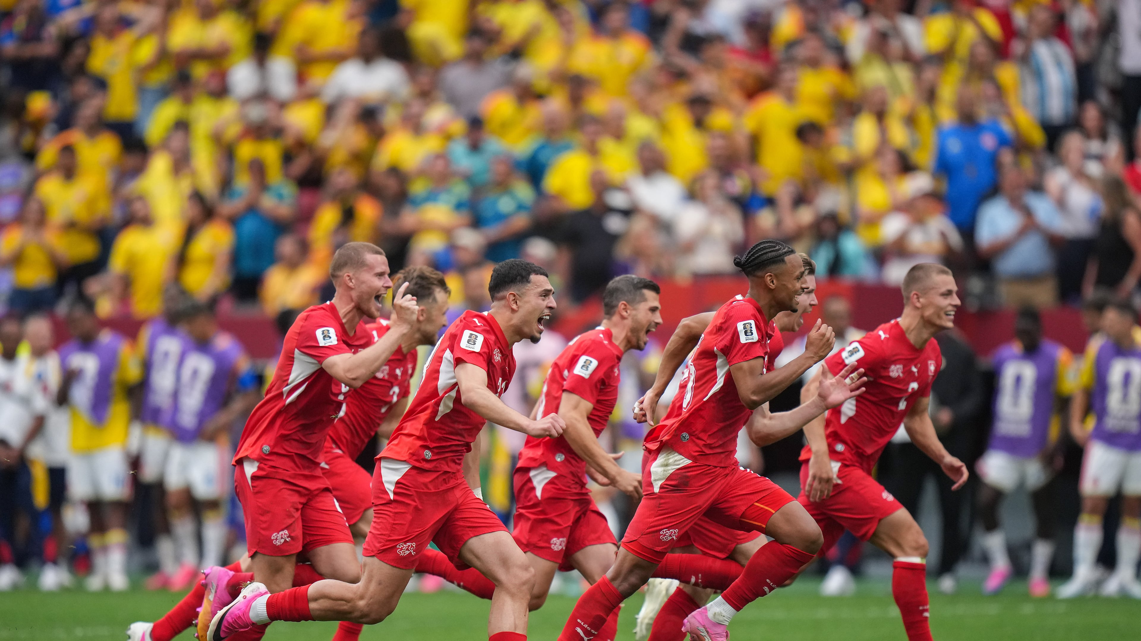 Switzerland players celebrate after defeating Colombia in a penalty shootout in the World Cup round of 16 soccer match between Switzerland and Colombia in Vancouver, British Columbia, Tuesday, July 7, 2026. (Darryl Dyck/The Canadian Press via AP)