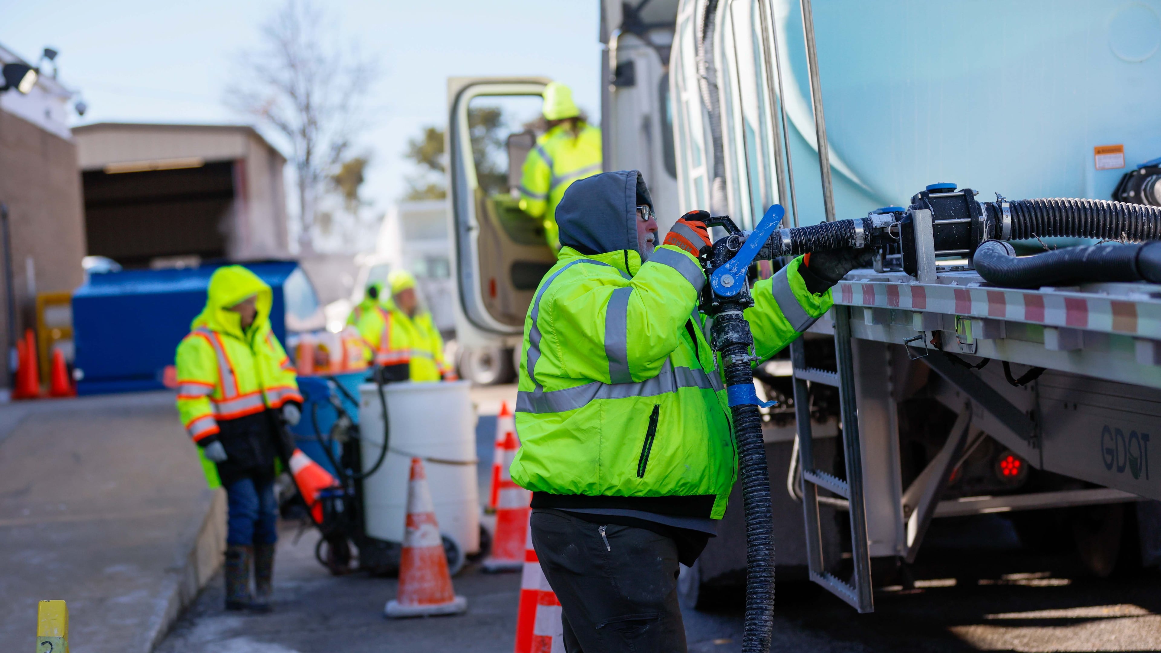 Georgia Department of Transportation workers — pictured filling their trucks with brine to treat roads ahead of the winter storm approaching in 2025 — will once again be ready to do their part as arctic air brings a mix of snow and ice to the state this weekend. (Miguel Martinez/AJC)