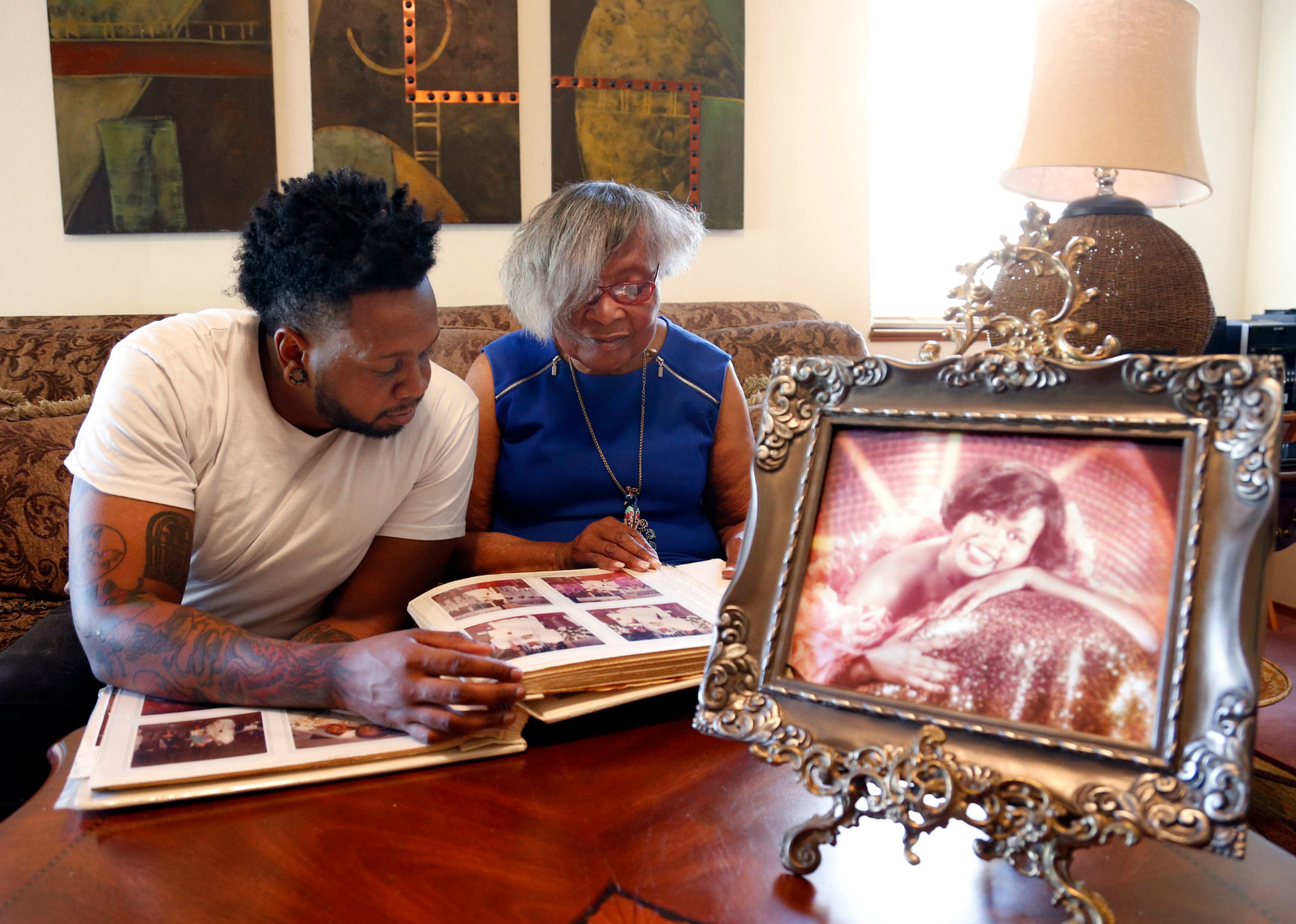 Helene Hunter watches as her grandson, Chaz Mabry, studies the wedding album of his mother Joyce Mabry, who was killed during the Loma Prieta earthquake 25 years ago. Helene Hunter is trying to spend as much time with Chaz, telling him about the mother he lost when he was only 3 years old. They spent the day reminiscing at her home in Berkeley, Calif., on October 12, 2014. (Karl Mondon/Bay Area News Group/MCT)