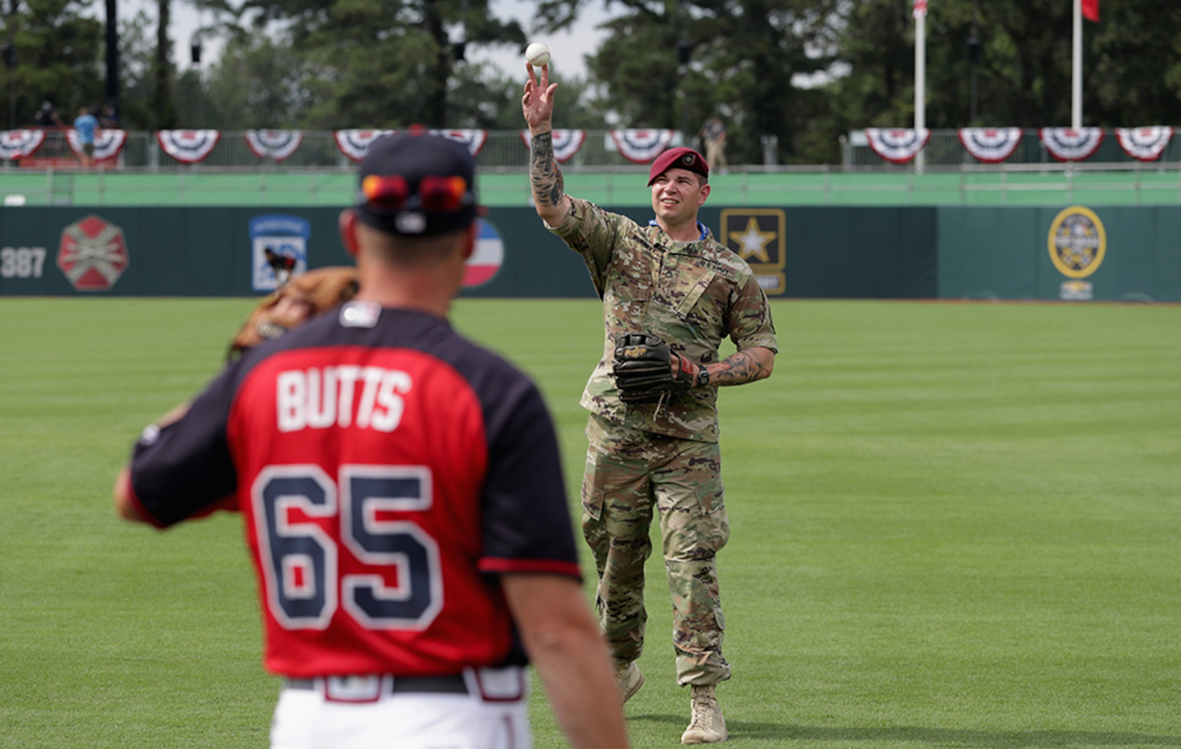 U.S. Army Sgt. Alex Burnette of the 82nd Airborne Division plays catch with Alan Butts of the Atlanta Braves prior to their game against the Miami Marlins on July 3, 2016 in Fort Bragg, N.C. The Fort Bragg Game marks the first regular season MLB game ever to be played on an active military base.