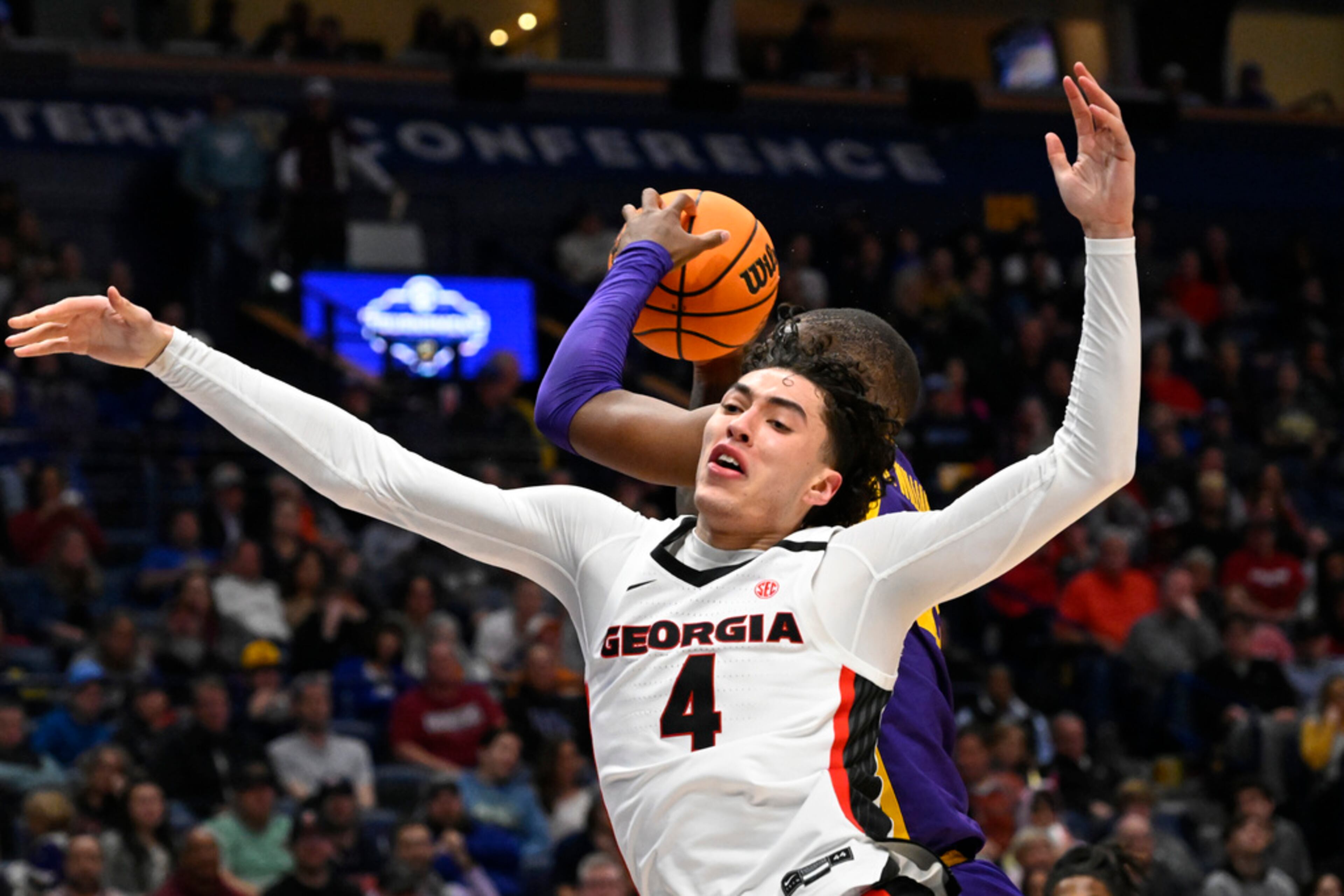 LSU forward KJ Williams grabs a rebound away from Georgia guard Jusaun Holt (4) during the first half of an NCAA college basketball game in the first round of the Southeastern Conference tournament, Wednesday, March 8, 2023, in Nashville, Tenn. Georgia lost 72-67. (AP Photo/John Amis)