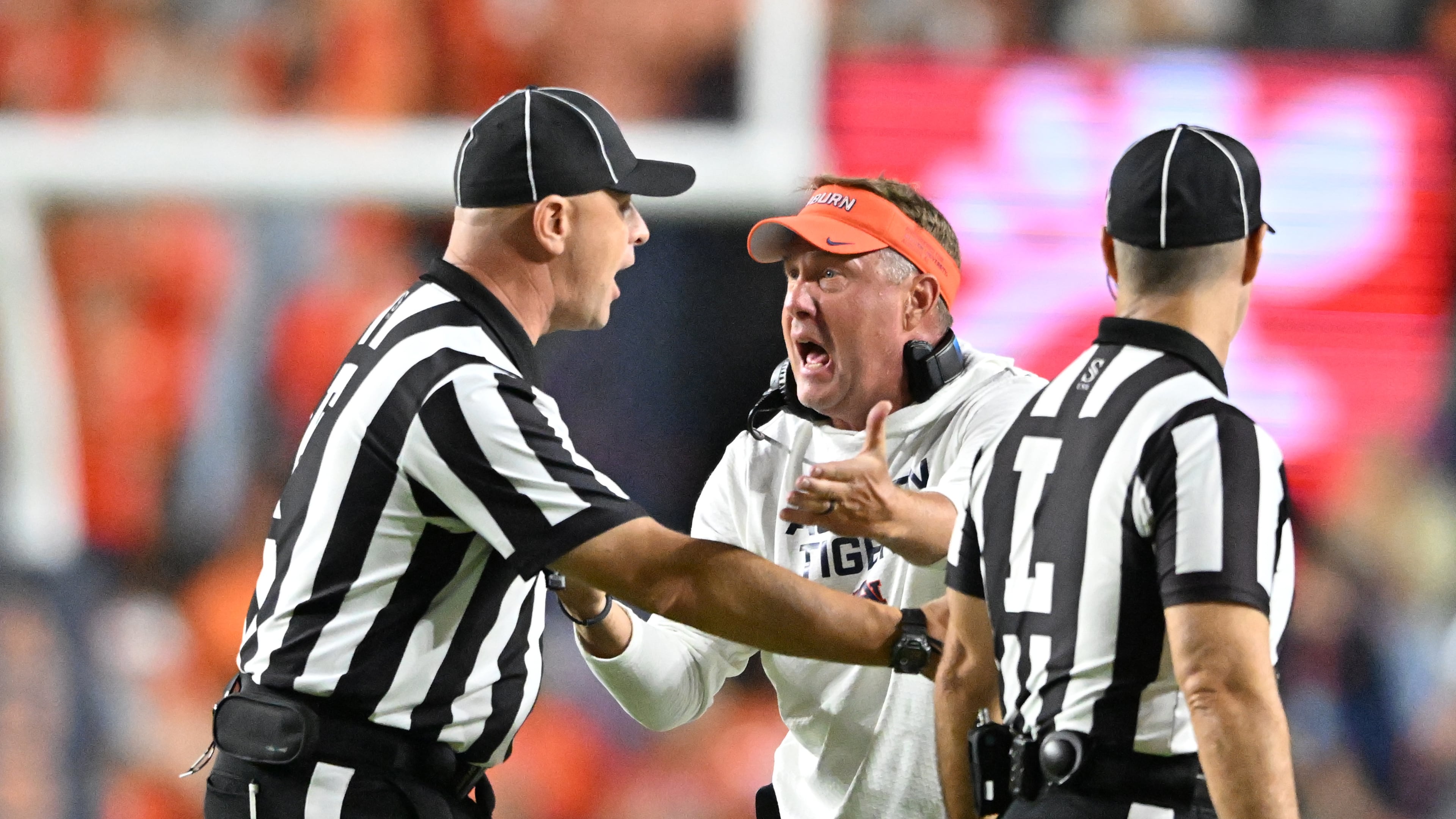Auburn coach Hugh Freeze (center) appeals to a referee during the second half against Georgia on Saturday, Oct. 11, 2025, at Jordan-Hare Stadium in Auburn, Ala. Georgia won 20-10 over Auburn. (Hyosub Shin/AJC)