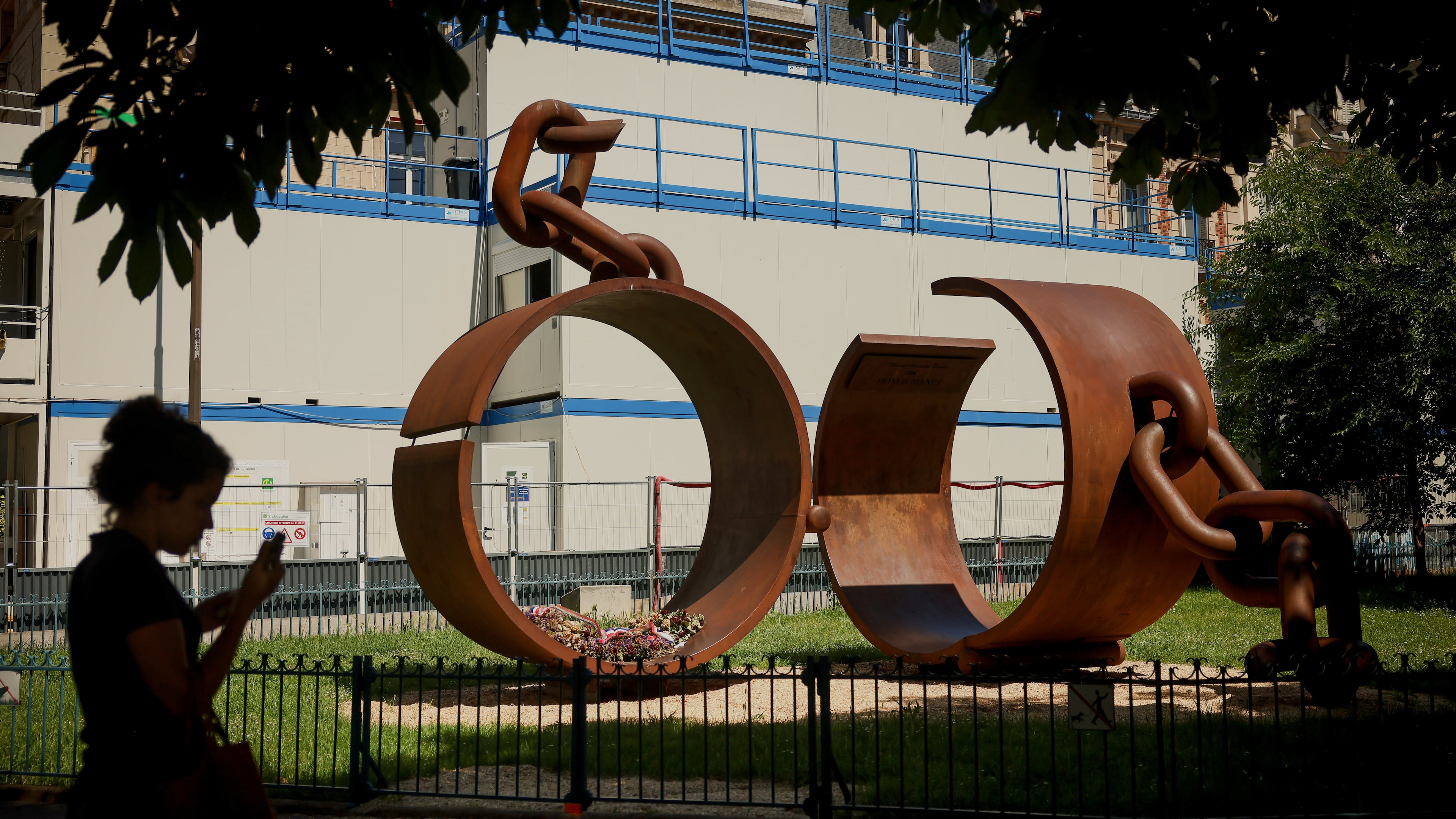 A statue named "Chains," by French artist Driss Sans-Arcidet, honoring the memory of the abolition of slavery, is photographed in a park in Paris, Wednesday, May 27, 2026, as France's National Assembly examines a bill to formally repeal the Code Noir, or Black Code, the 17th-century royal edict that governed slavery in French colonies and treated enslaved people as property. (AP Photo/Thomas Padilla)