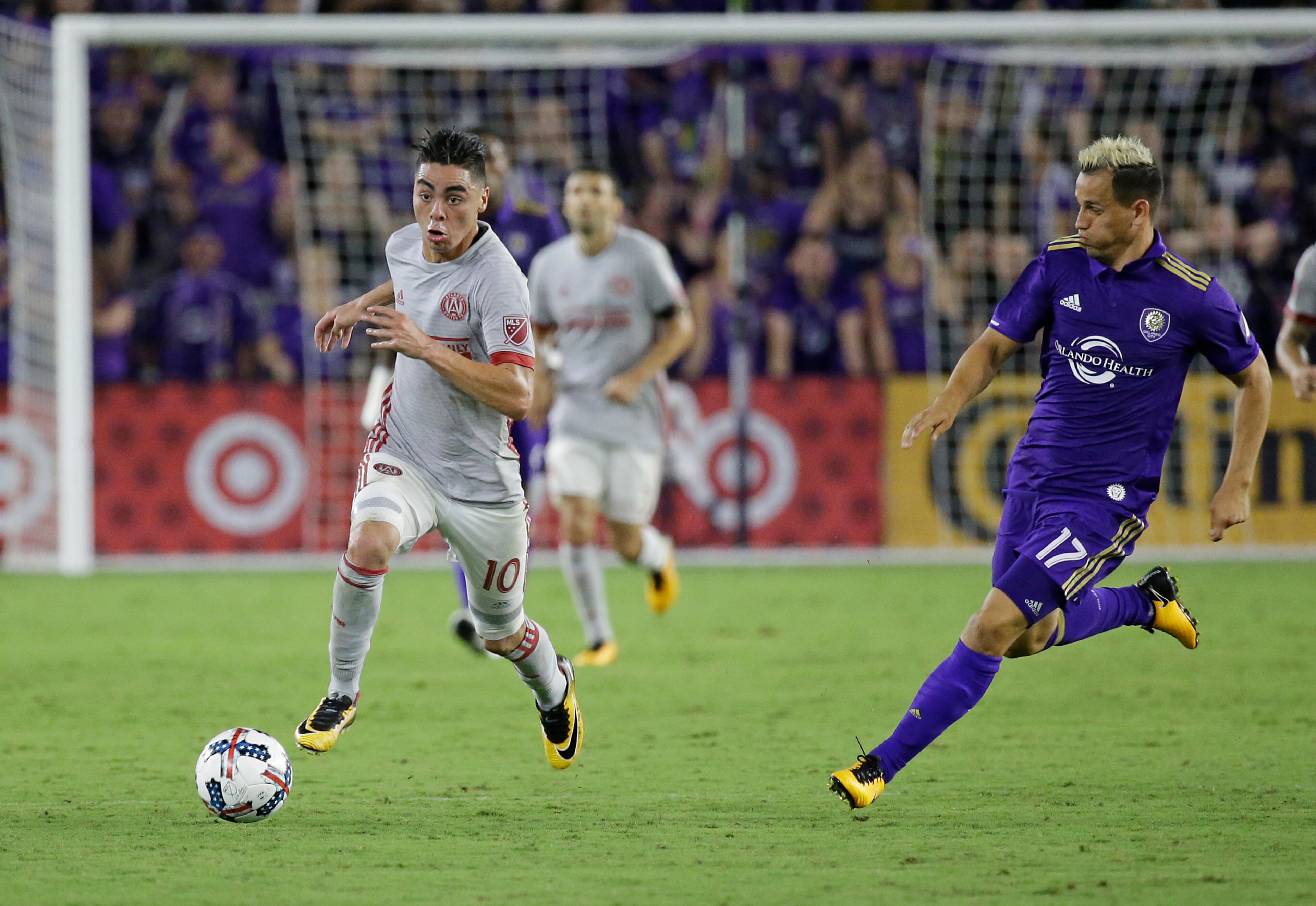 Atlanta United's Miguel Almiron (10) moves the ball past Orlando City's Luis Gil during the second half of an MLS soccer match, Friday, July 21, 2017, in Orlando, Fla. Atlanta United won 1-0. (AP Photo/John Raoux)