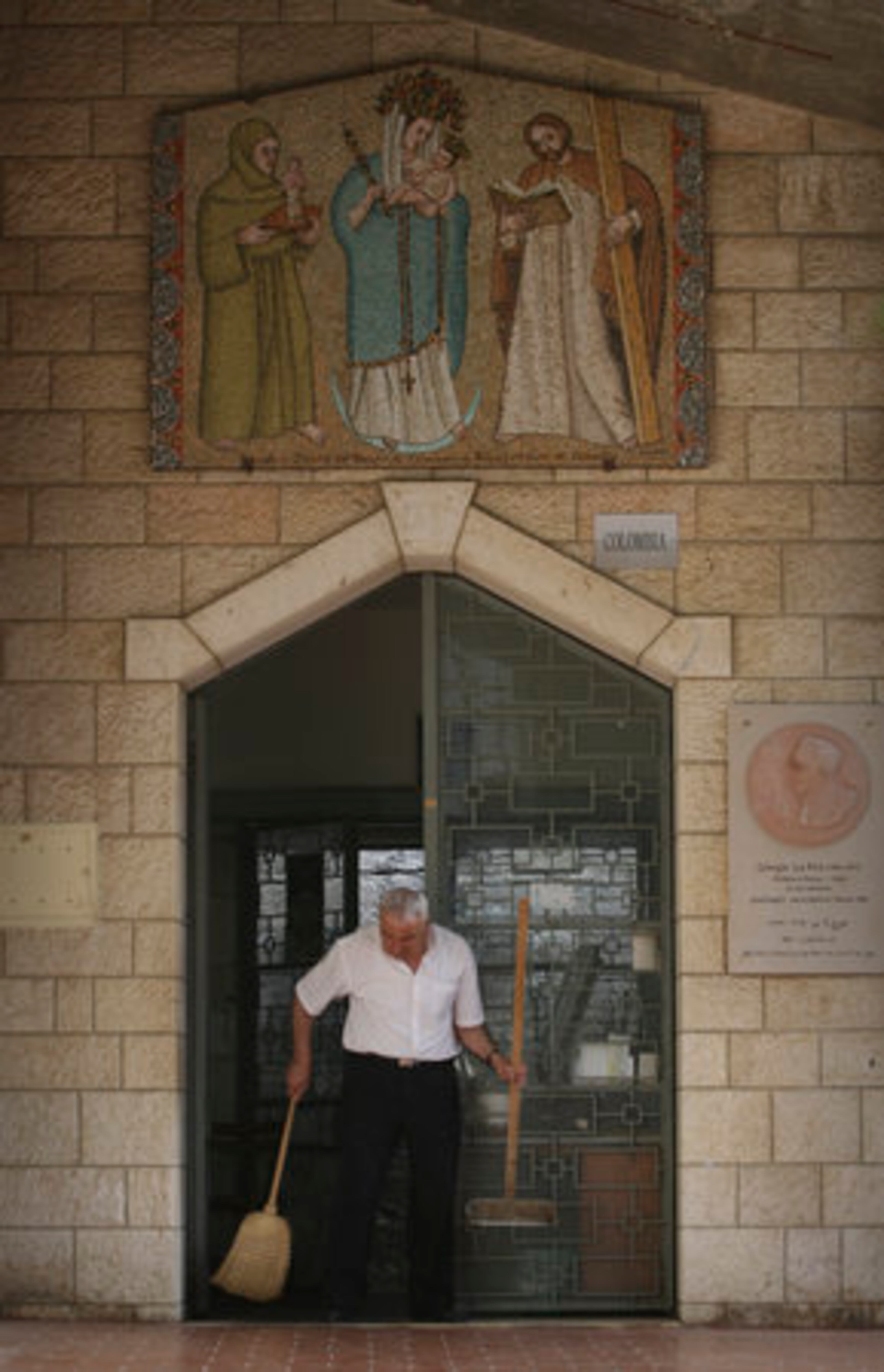 A man cleans the courtyard around the Church of Annunciation in Nazareth, where Mary, Jesus' mother, received the news that she would give birth to God's son.
