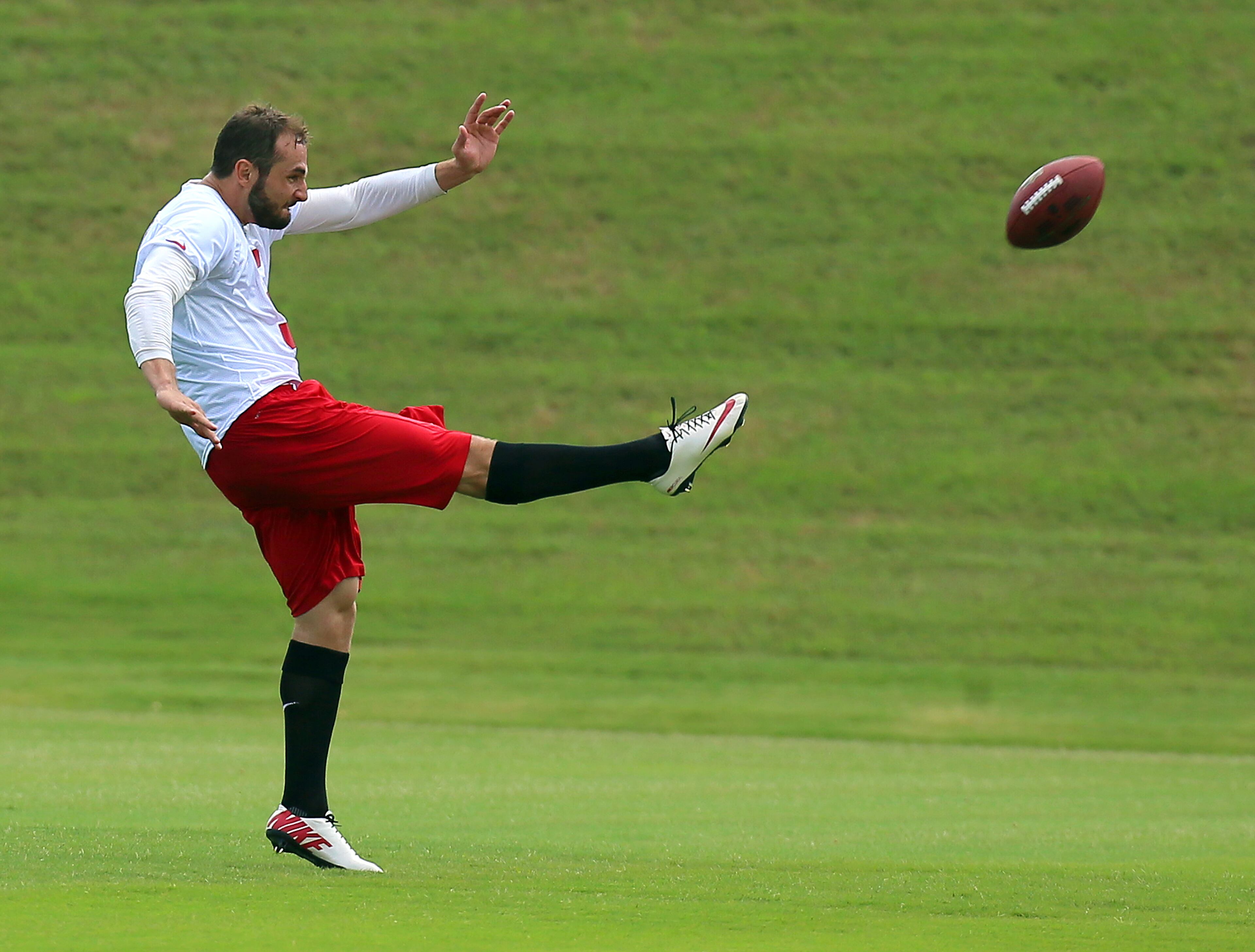 Falcons punter Matt Bosher gets off a punt during practice. CURTIS COMPTON / CCOMPTON@AJC.COM