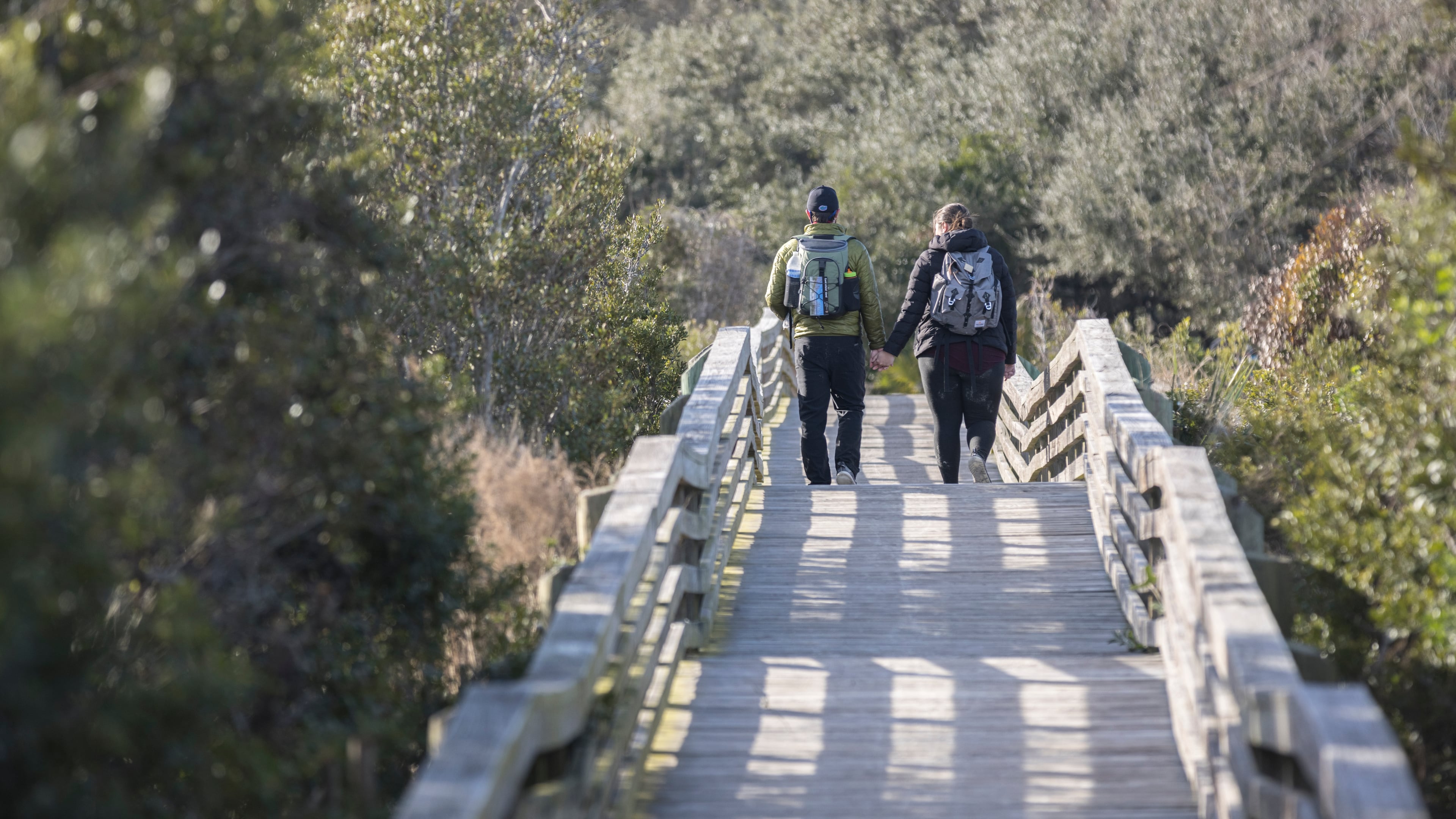 A couple takes the Sea Camp boardwalk as they spend their wedding anniversary enjoying the national seashore in Cumberland Island. The island is big enough to welcome both the public visitor and the private property holder to enjoy its beauty, guest columnist Sam Candler writes. (Stephen B. Morton/AJC 2022)