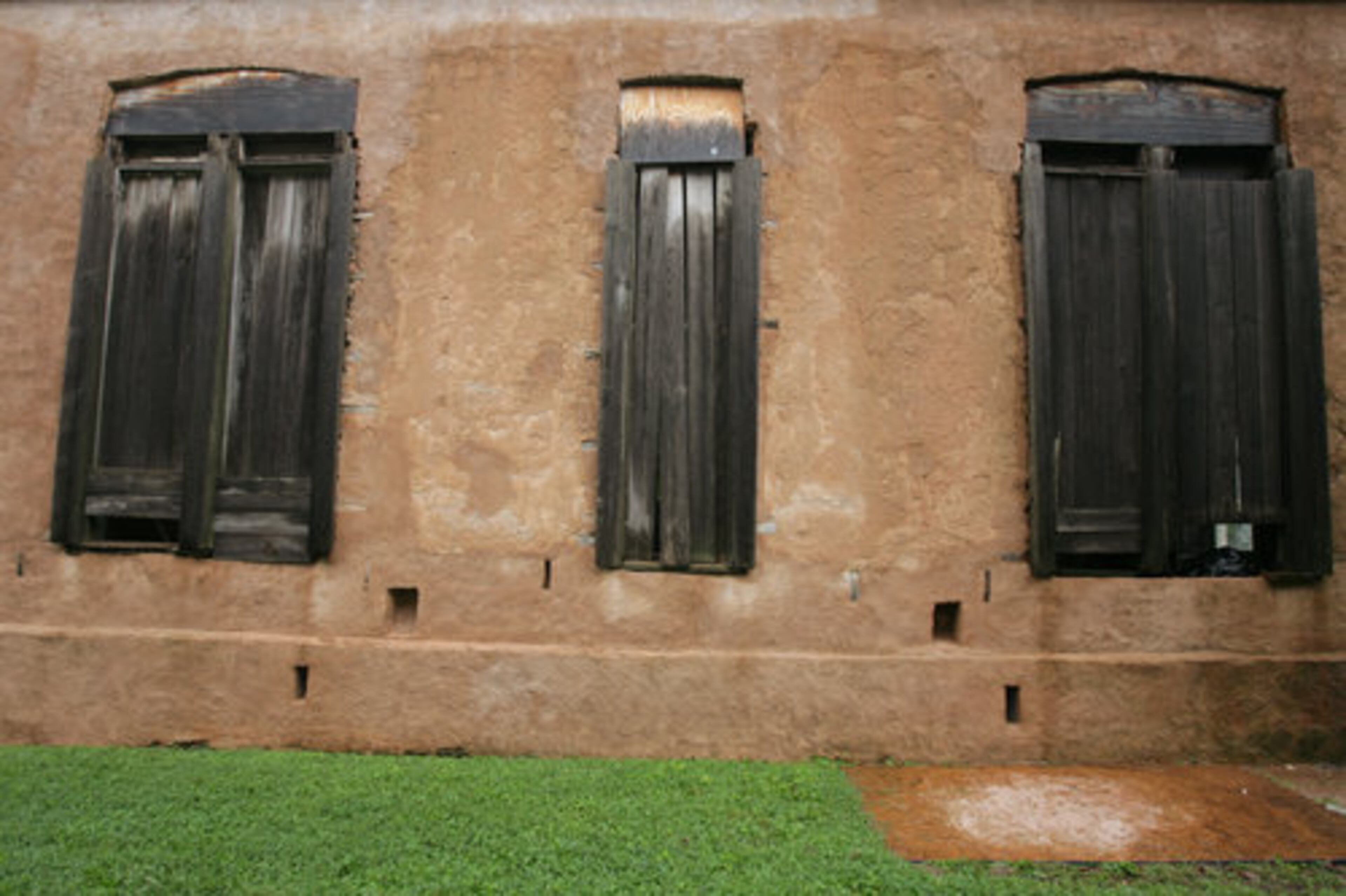 This exterior wall gives an idea of what much of the mansion looked like before restoration began.