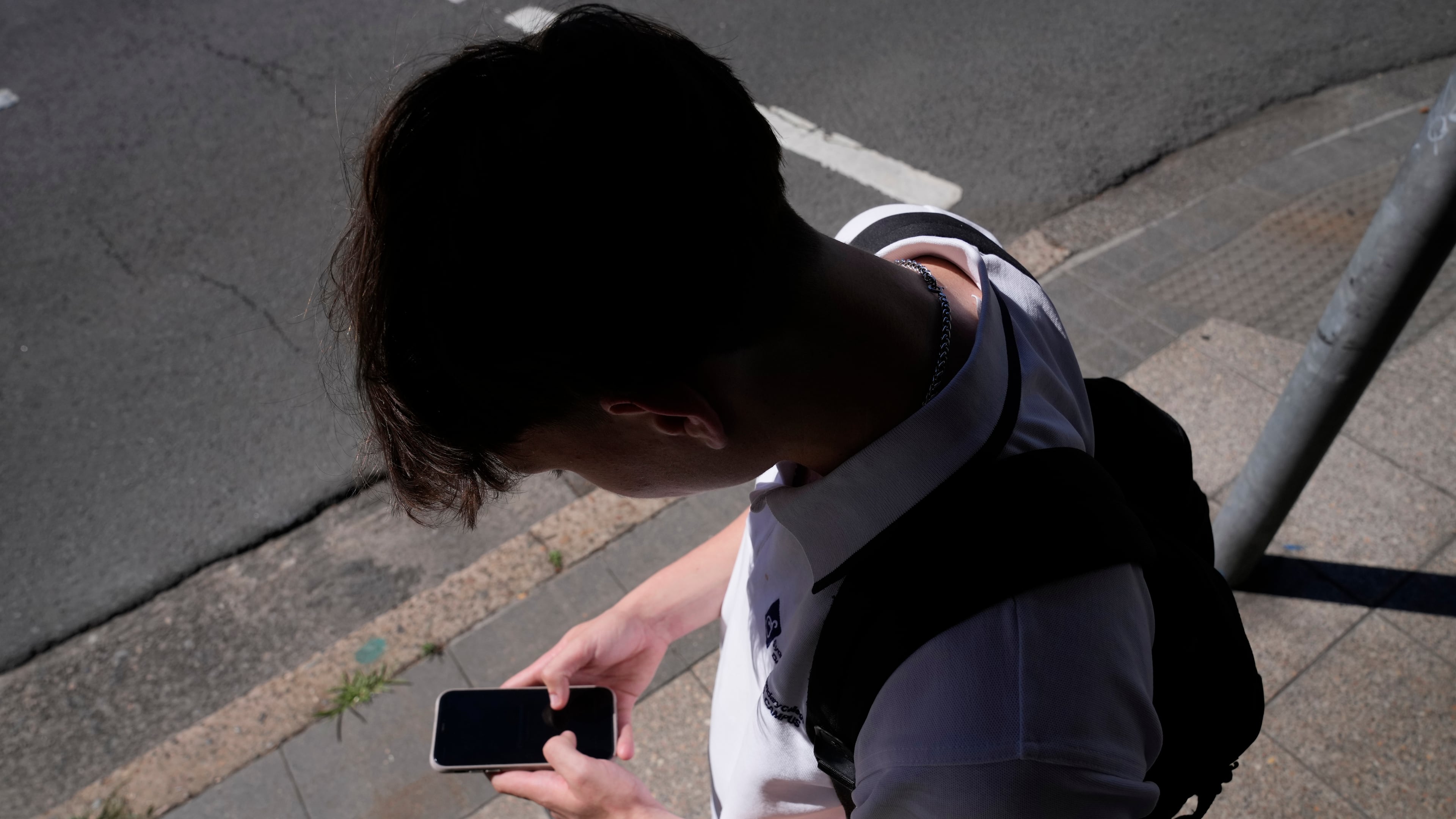 FILE - A teenage boy uses his phone in Sydney, Nov. 8, 2024. (AP Photo/Rick Rycroft, File)