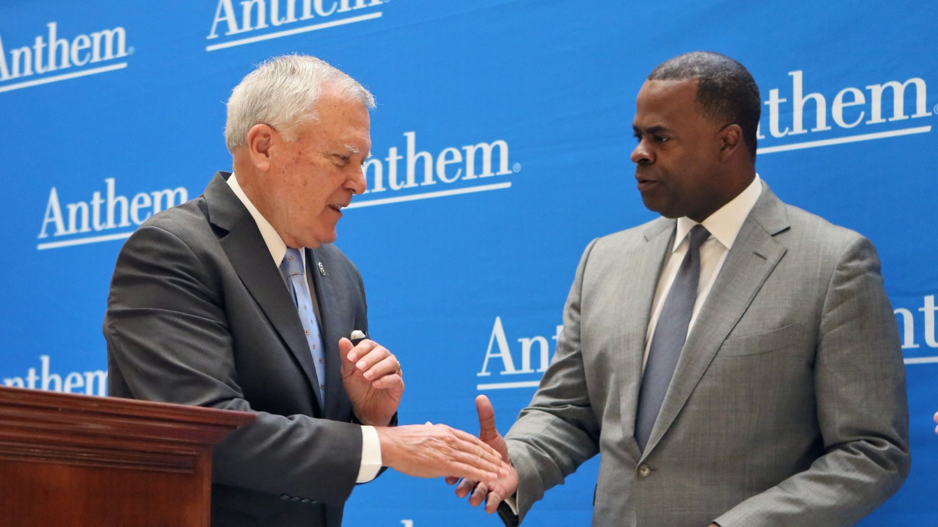 In this 2016 photo, Gov. Nathan Deal and former Atlanta Mayor Kasim Reed stand in front of a wall printed with the name of Anthem, the parent company of Blue Cross Blue Shield of Georgia. This week, Deal has announced that for the first 30 days the state will pay the extra out-of-network costs for state employees who have a state Blue Cross insurance plan and see Piedmont healthcare providers. The move could cost the state about $42 million. The state university system has done the same. PHOTO by BOB ANDRES /BANDRES@AJC.COM