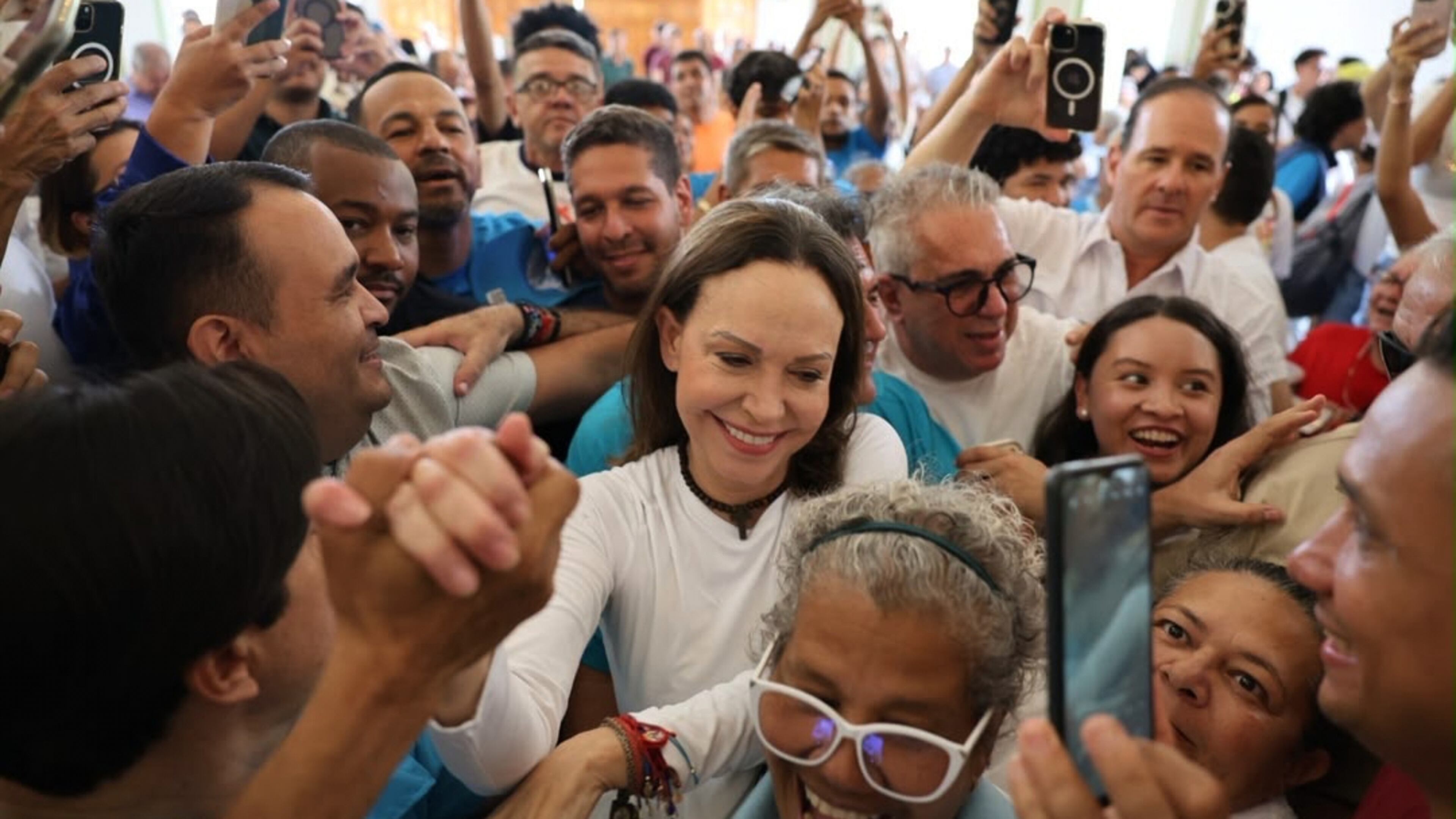 In this photo released by Vente Venezuela Press Office, Venezuelan opposition leader Maria Corina Machado greets supporters at a church in Barquisimeto, Venezuela, Sunday, Oct. 25, 2026. (Vente Venezuela Press Office via AP)