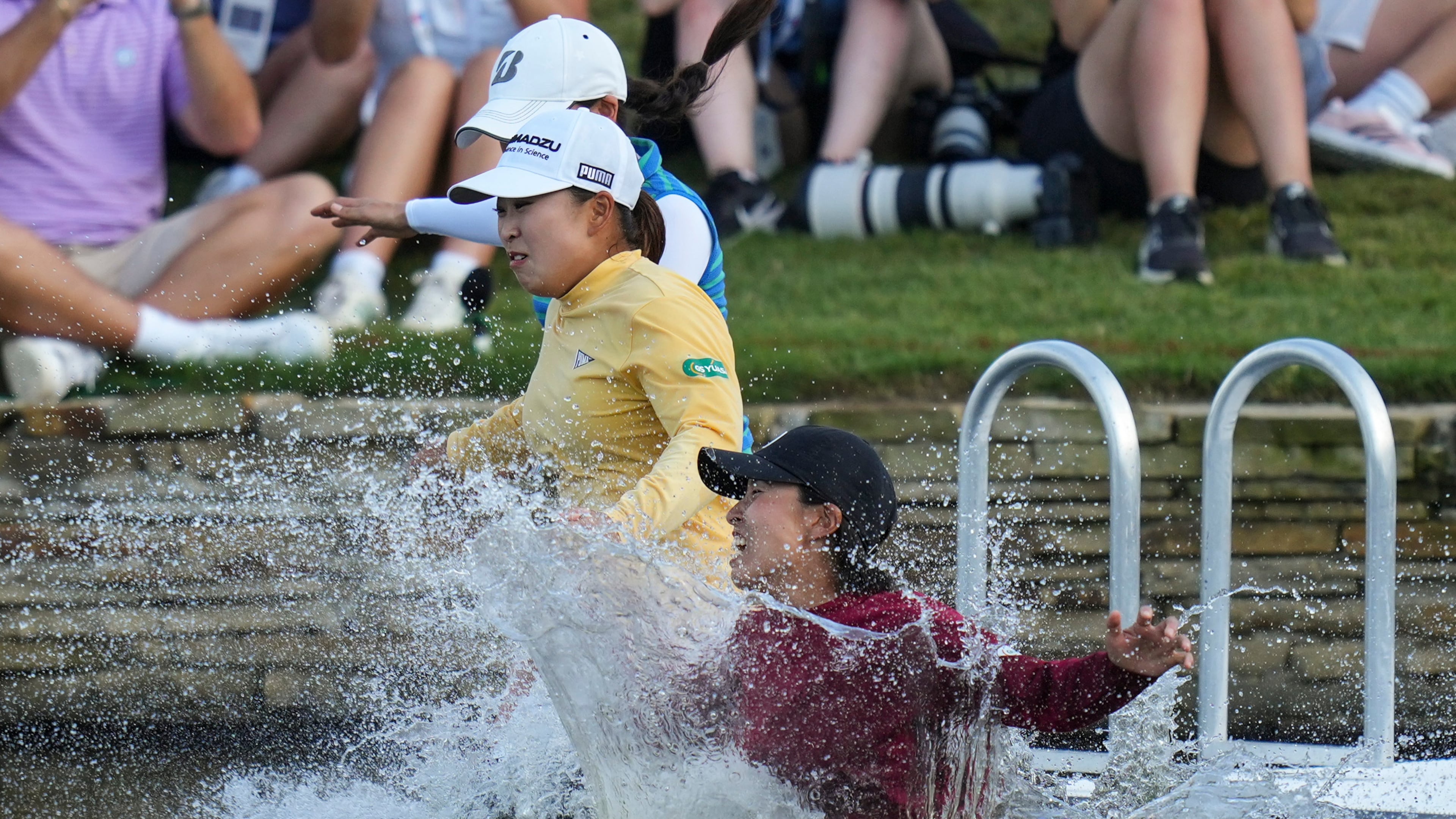 FILE -Mao Saigo, of Japan, in yellow, jumps into the water after winning the Chevron Championship LPGA golf tournament April 27, 2025, in The Woodlands, Texas. (AP Photo/Eric Gay, File)