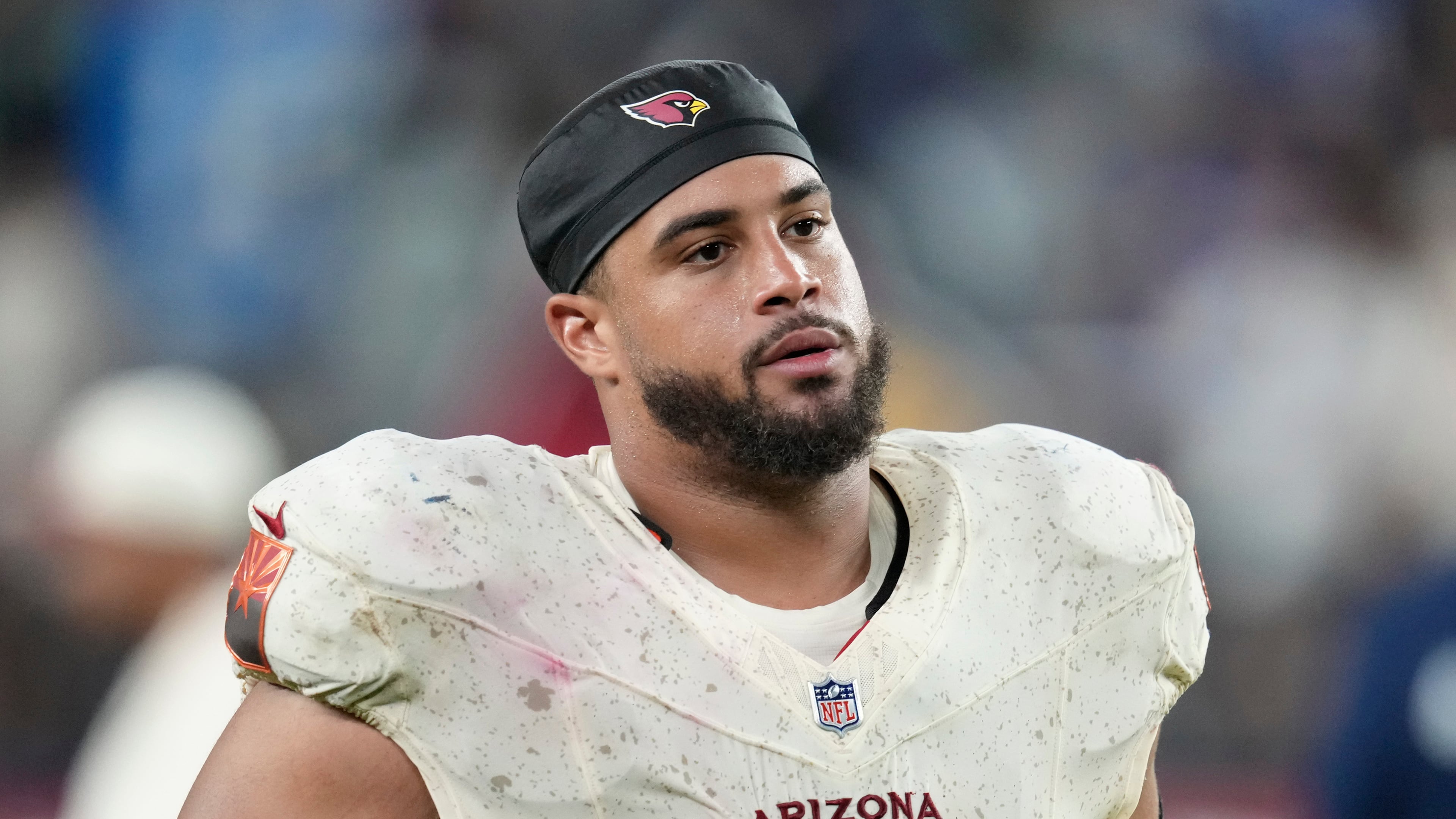 FILE - Arizona Cardinals guard Isaiah Adams walks off the field after an NFL football game against the Seattle Seahawks, Sept. 25, 2025, in Glendale, Ariz. (AP Photo/Ross D. Franklin, File)