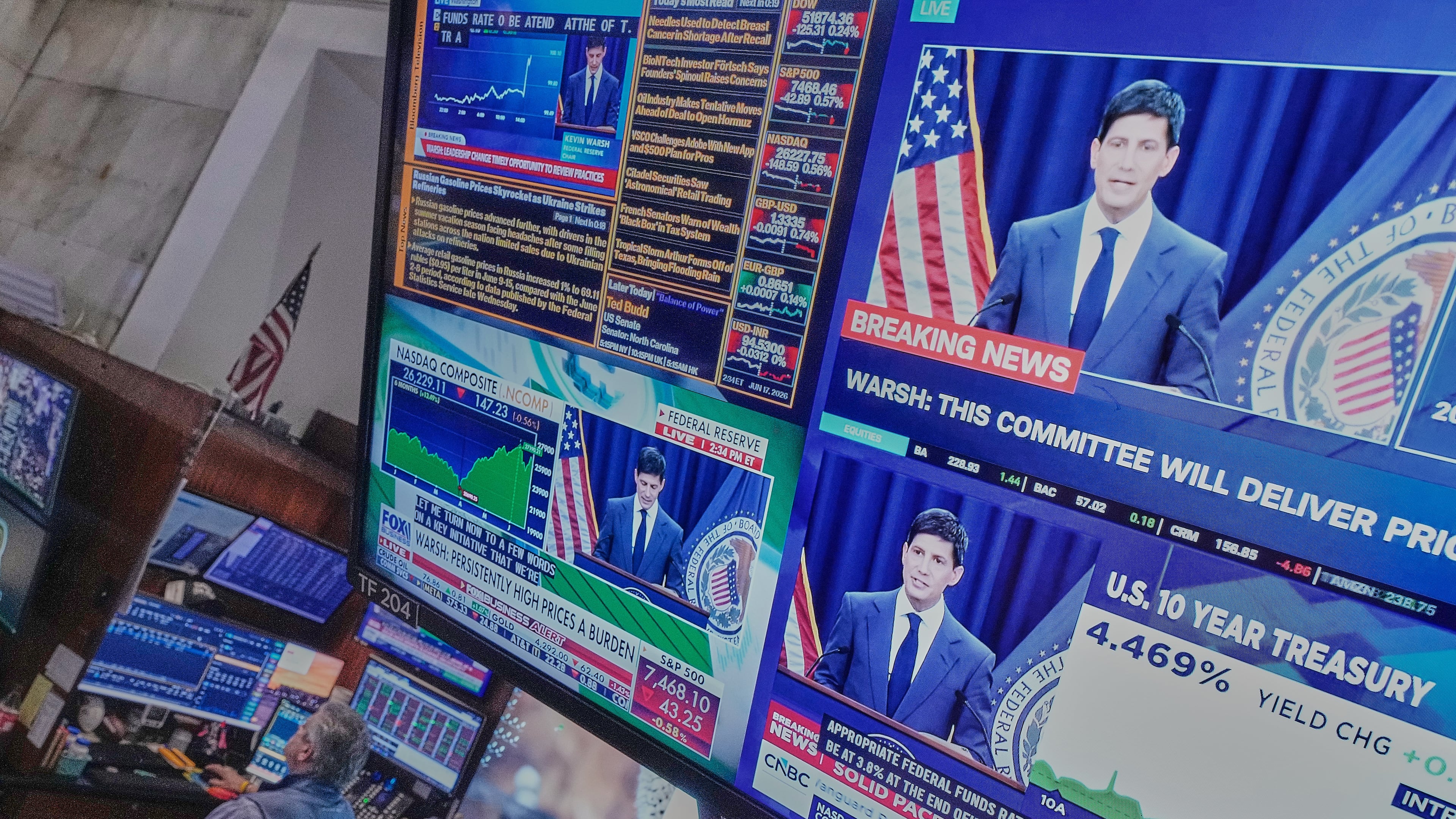 Federal Reserve Chair Kevin Warsh's press conference appears on screens on the floor of the New York Stock Exchange, Wednesday, June 17, 2026. (AP Photo/Richard Drew)
