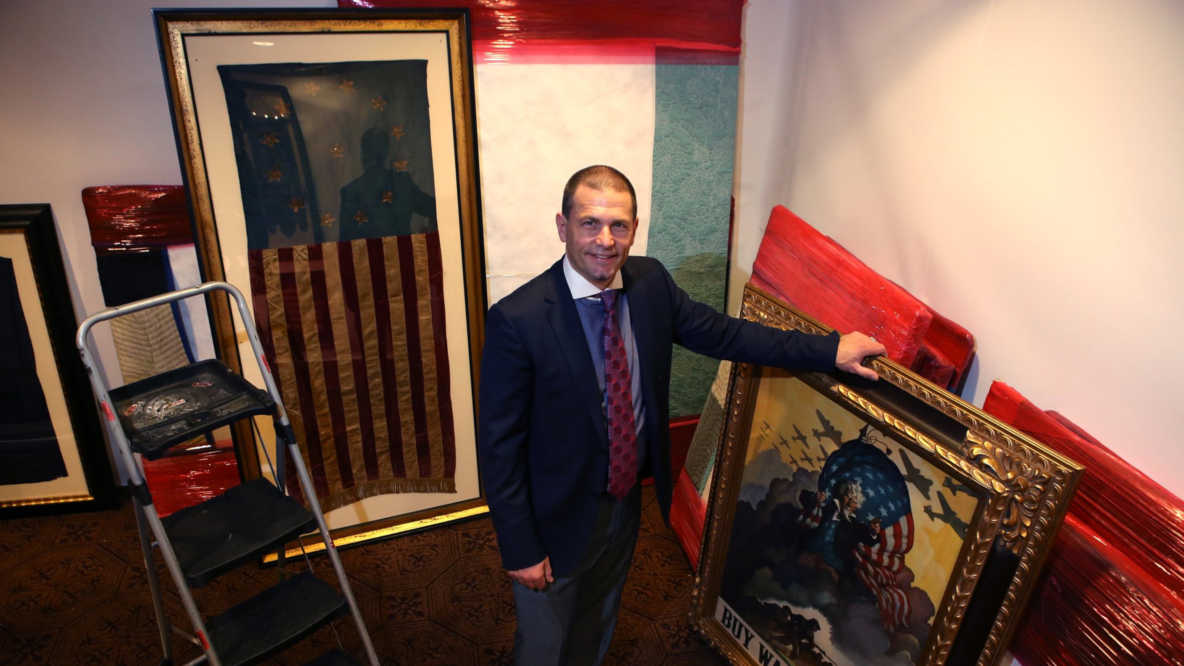 Jeff Bridgman, 49, owner of Jeff R. Bridgman Antiques Inc., poses for a portrait Tuesday amid preparations for the 2017 Cathedral Antiques Show in Atlanta. Bridgman is the nation’s largest collector and dealer of antique American flags, and he’s bringing a portion of his collection to this week’s show. HENRY TAYLOR / HENRY.TAYLOR@AJC.COM