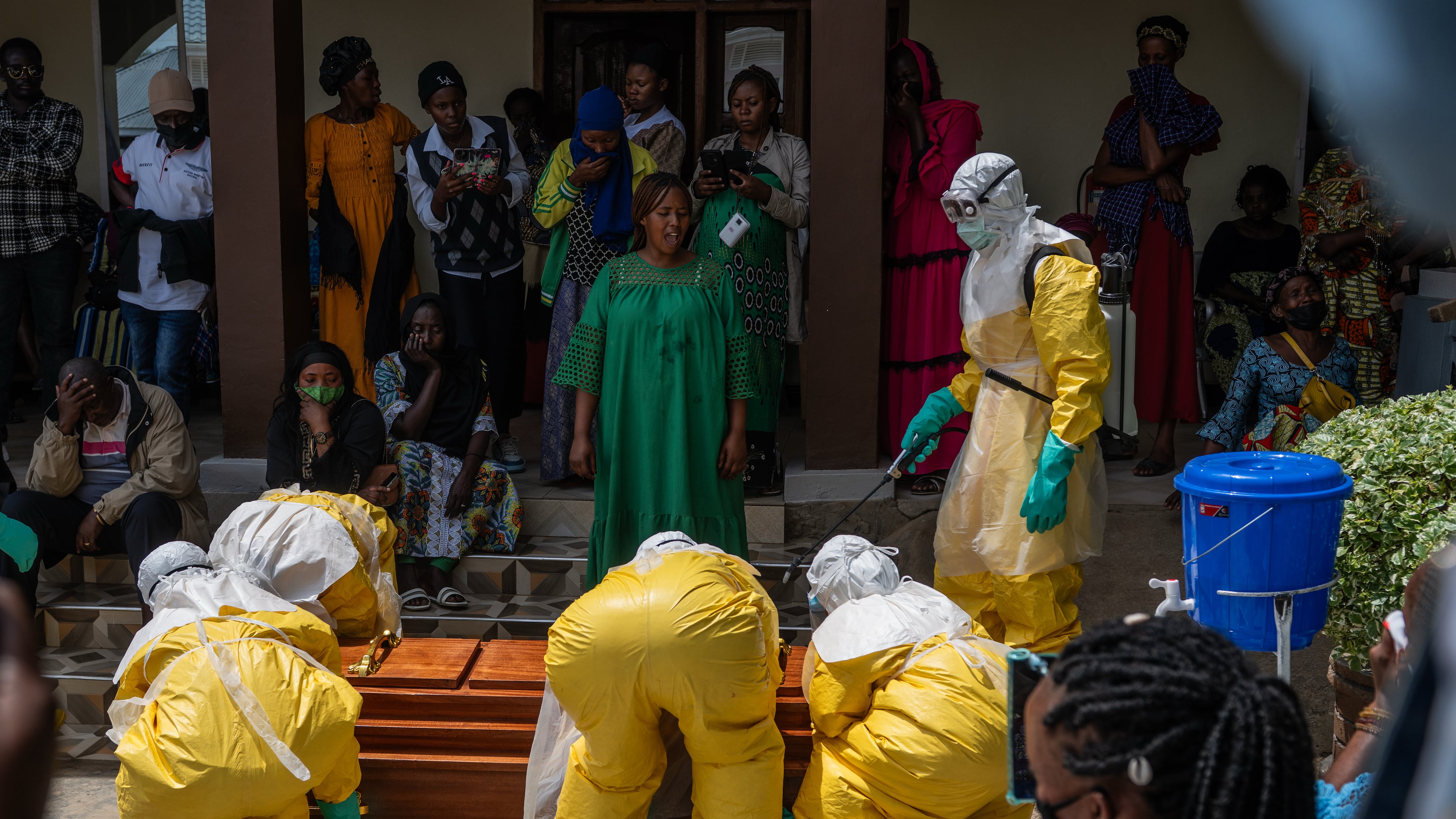 Family members of an Ebola victim mourn as the coffin is taken away for burial, at Sofepadi Hospital in Bunia, Congo, Saturday, May 23, 2026. (AP Photo/Moses Sawasawa)