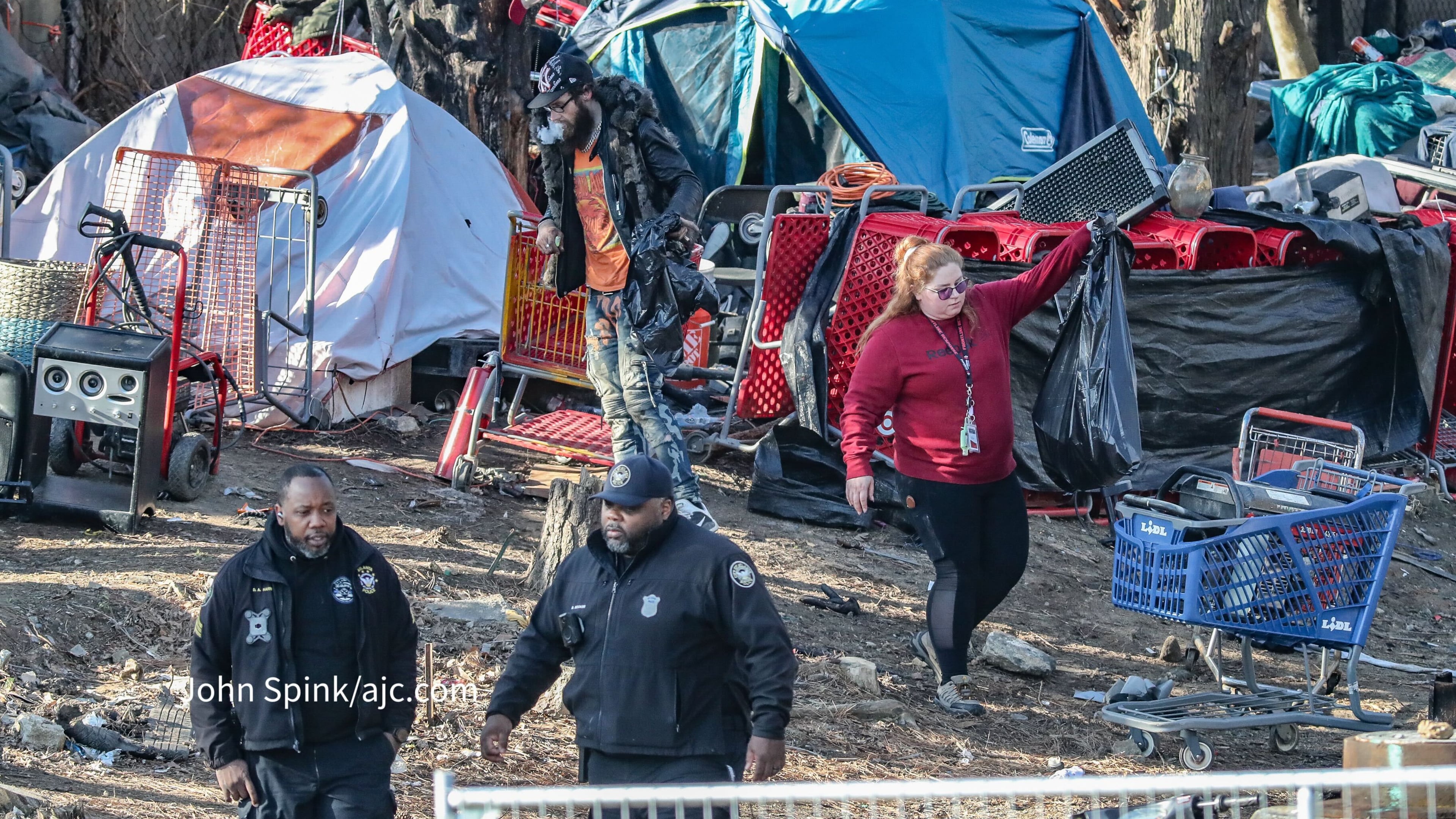 Atlanta Police and GDOT personnel clear a homeless encampment Monday.