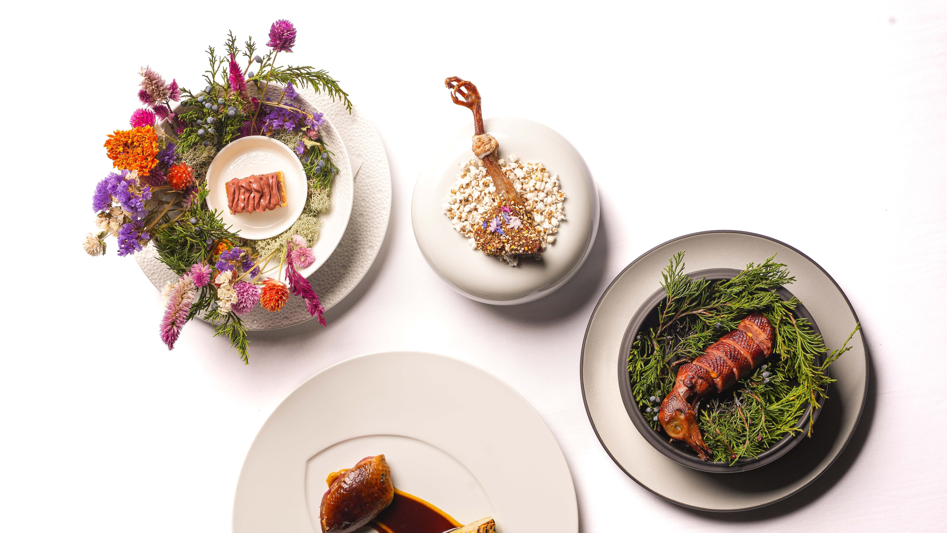 A suite of four squab dishes called the Whole Bird is served at Atlas at the St. Regis Buckhead. (Courtesy of Atlas)