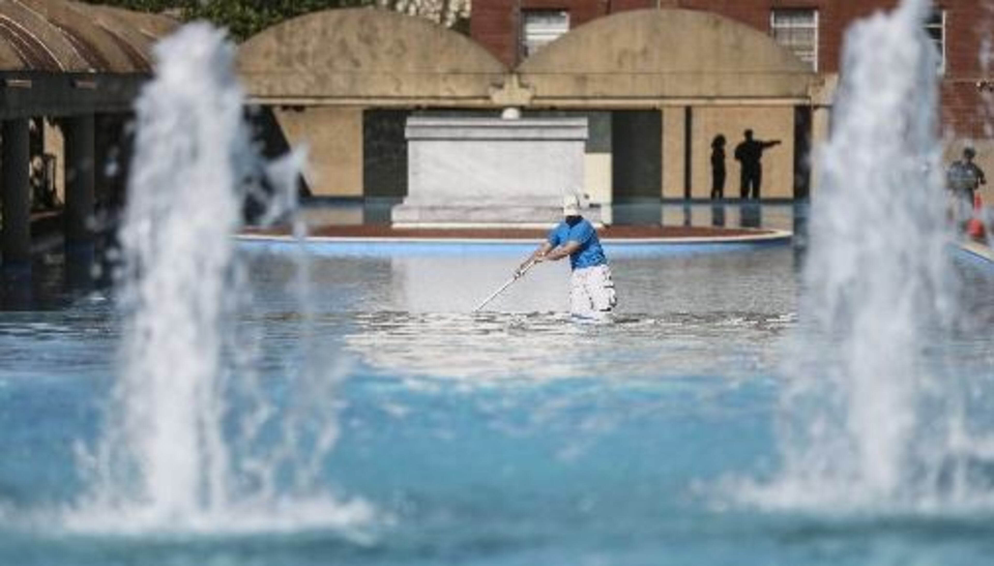 Matt Sutter with American Pools works on the reflecting pool on a clear day at the Martin Luther King Jr. Center for Nonviolent Social Change. JOHN SPINK / JSPINK@AJC.COM