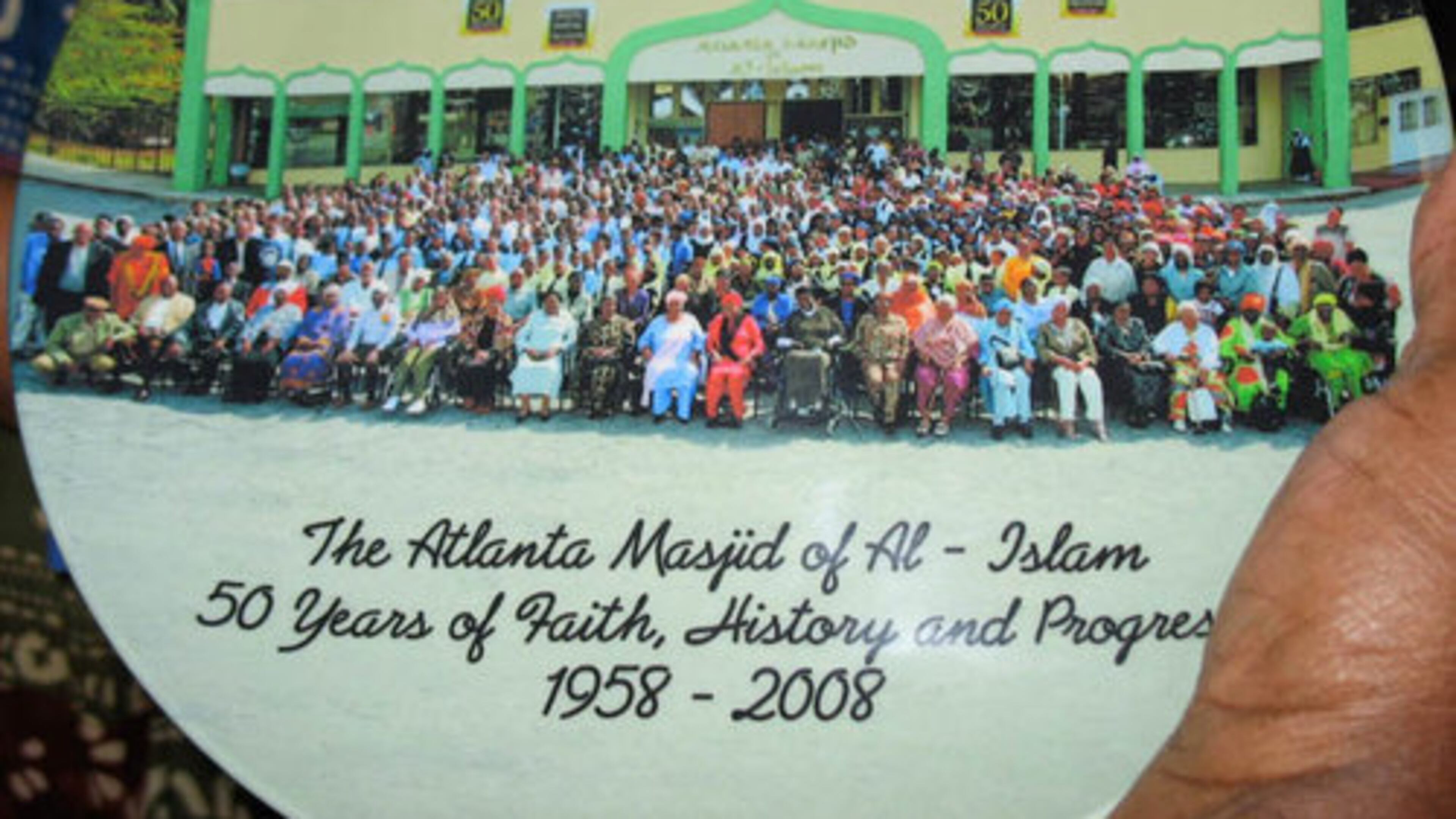 The festivities, which run Oct. 16-19, include a fashion show, a gala featuring Mayor Shirley Franklin, a 5K fund raiser for Mohammed Schools, a men's discussion on "responsibilities of manhood" and an interfaith program. Pictured, a member displays a commemorative plate on the congregation's 50th anniversary.