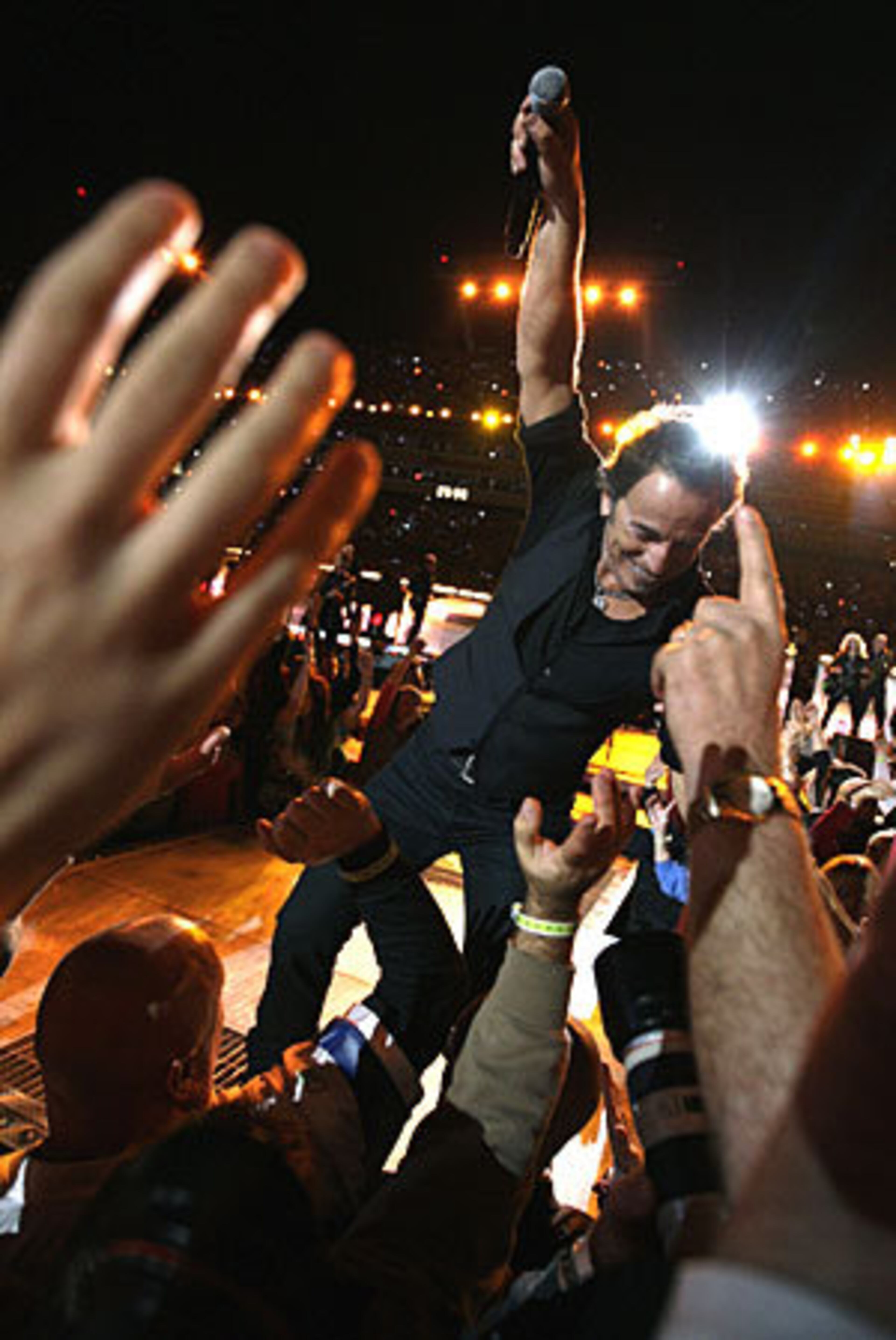 Bruce Springsteen invites the Super Bowl fans to join in as he performs.