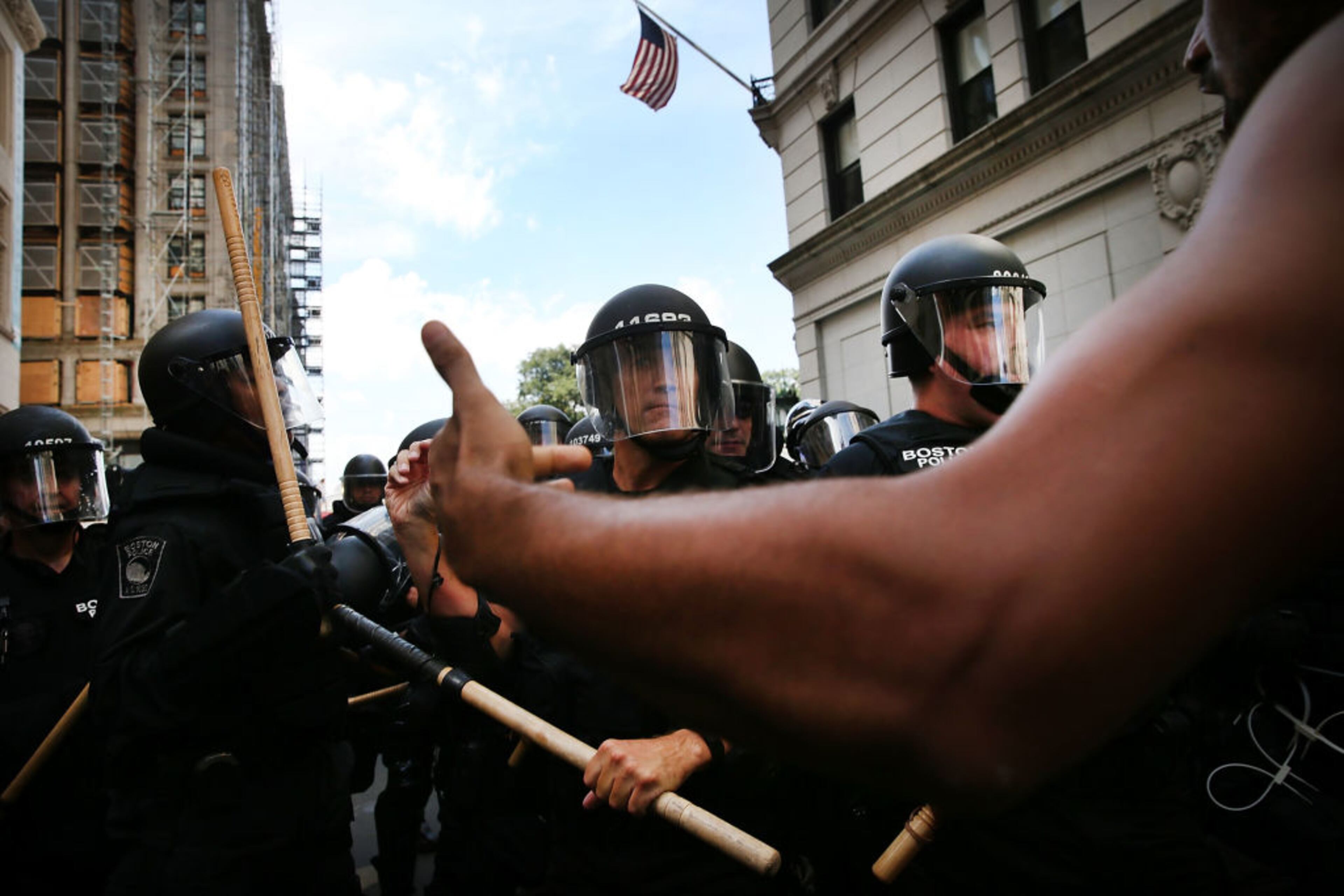 BOSTON, MA - AUGUST 19: Protesters face off with riot police following a march in Boston against a planned 'Free Speech Rally' just one week after the violent 'Unite the Right' rally in Virginia left one woman dead and dozens more injured on August 19, 2017 in Boston, United States. Although the rally organizers stress that they are not associated with any alt-right or white supremacist groups, the city of Boston and Police Commissioner William Evans are preparing for possible confrontations at the afternoon rally. (Photo by Spencer Platt/Getty Images)