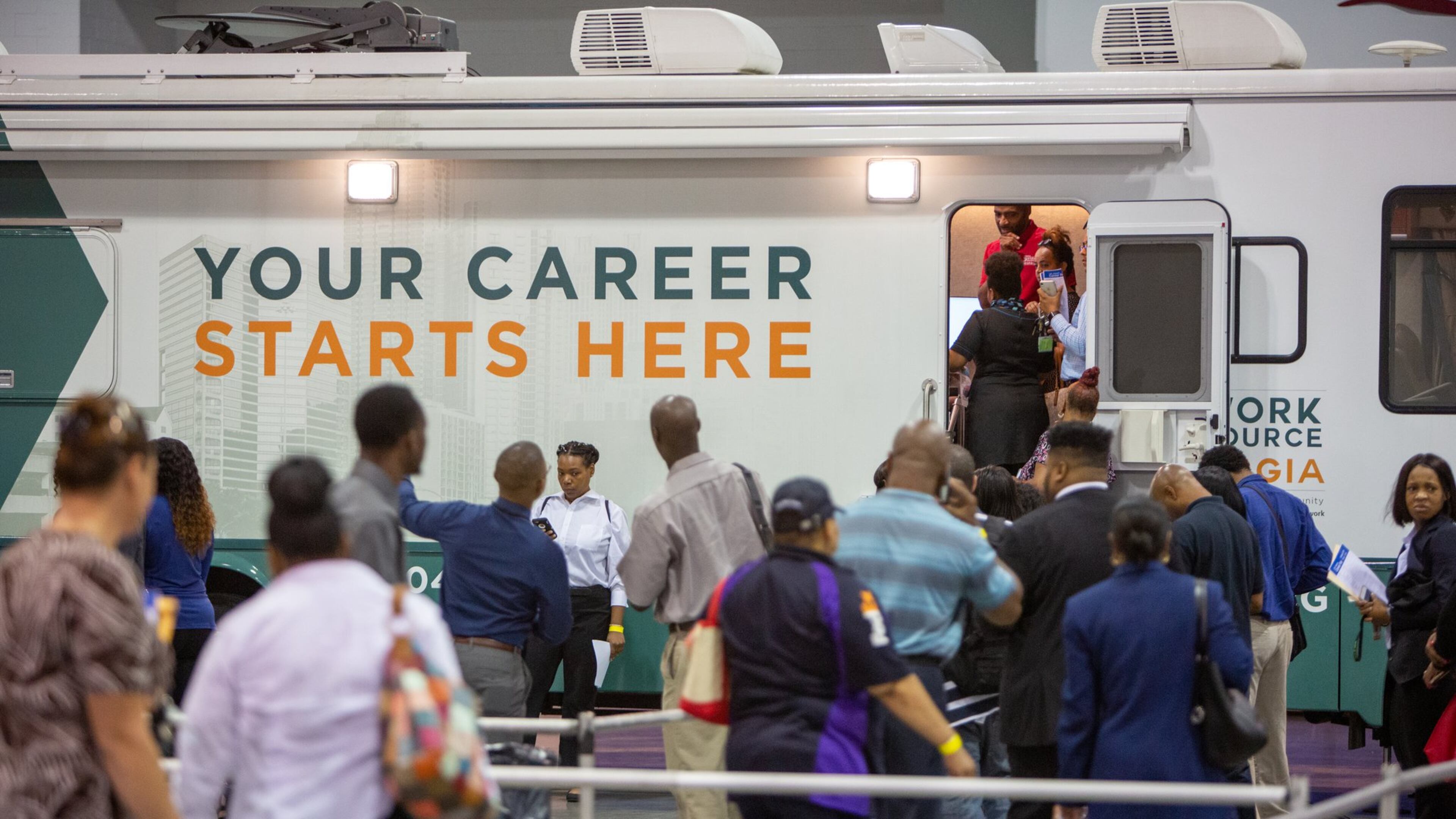 A low unemployment rate means most people who want jobs can eventually find one, but at any moment, many tens of thousands of Georgians are out of work and looking for their next position. Here, job seekers registered at a job fair held Oct. 8 at the Georgia International Convention Center. (Photo by Phil Skinner)