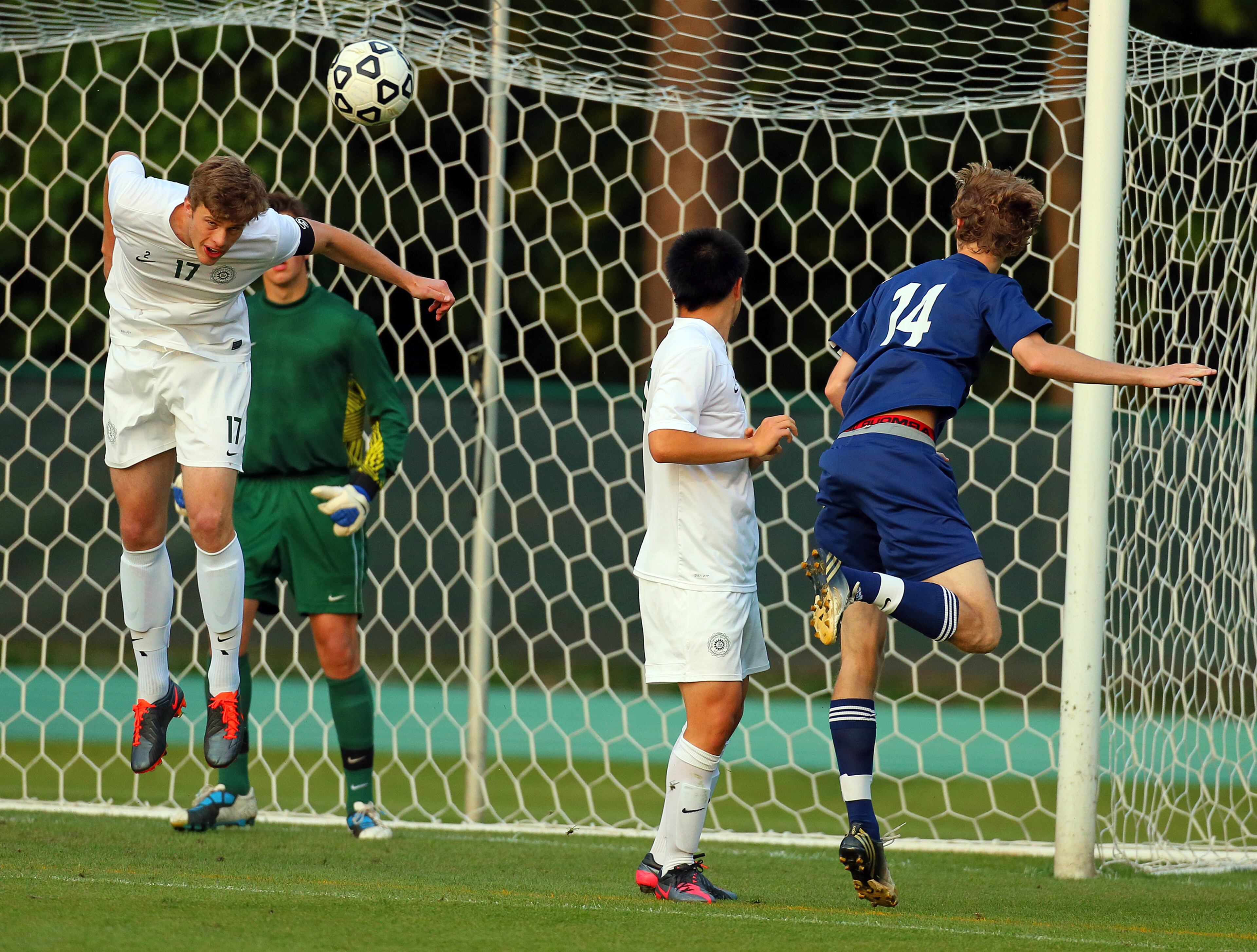 Westminster's Harrison Butker (left) helps his goalkeeper, blocking a shot by Lovett's Alan Floyd (far right).