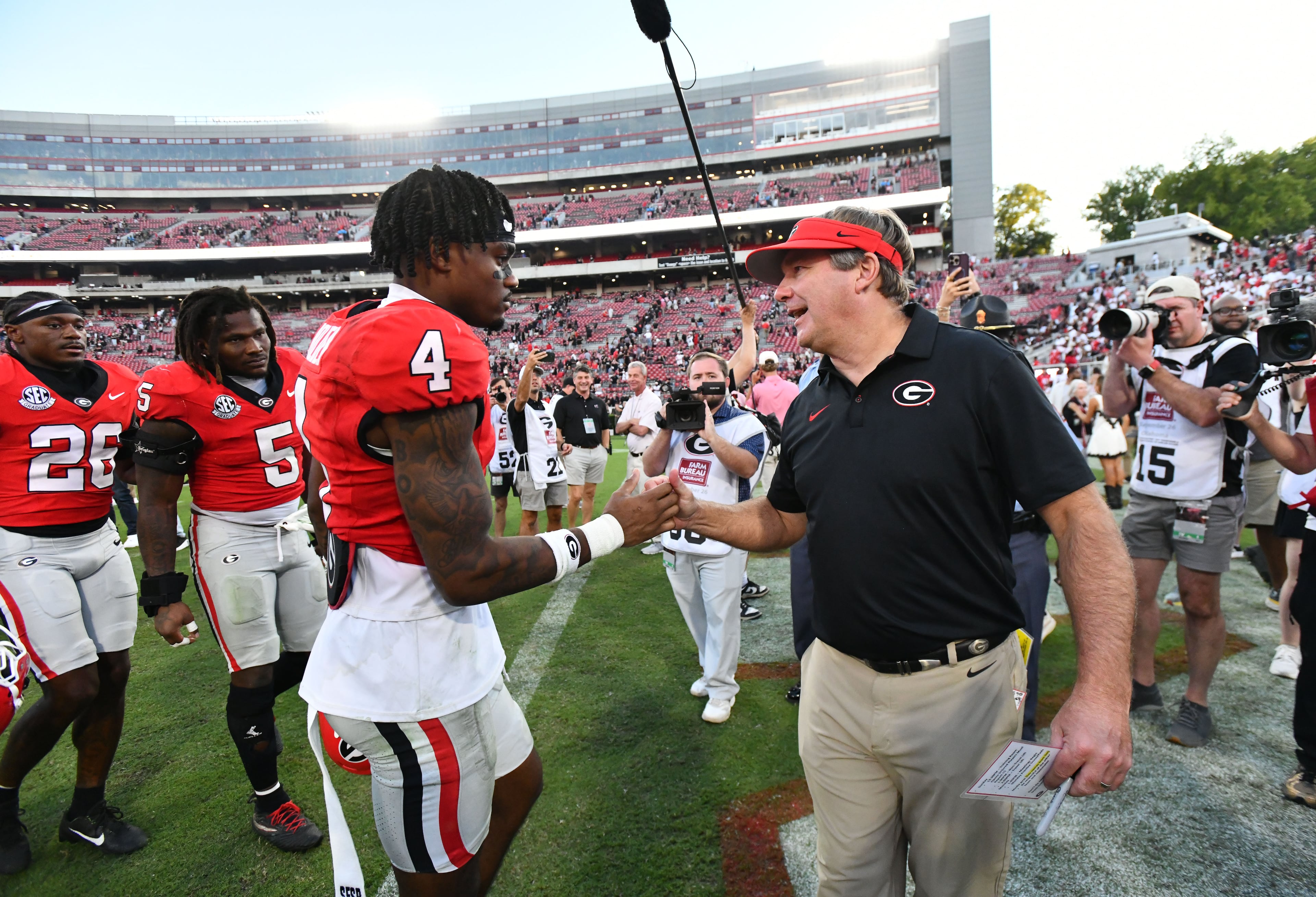 Georgia head coach Kirby Smart celebrates with wide receiver CJ Wiley after Georgia defeated Oklahoma 41-13 in an NCAA football game at Sanford Stadium on Saturday, Sept. 26, 2026, in Athens, Ga. (Hyosub Shin/AJC)