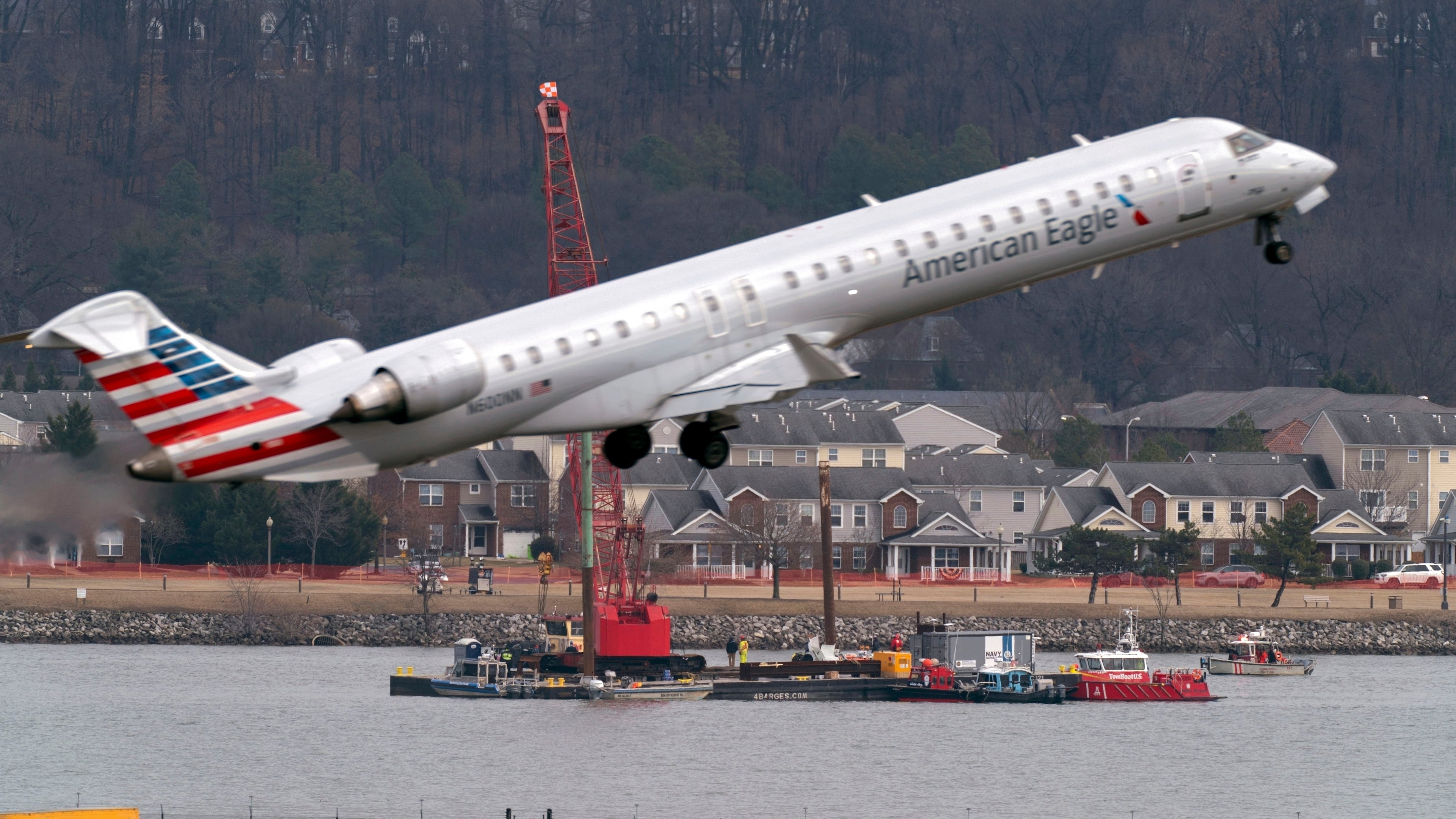 FILE - Salvage crews work on recovering wreckage near the site in the Potomac River of a mid-air collision between an American Airlines jet and a Black Hawk helicopter at Ronald Reagan Washington National Airport, Feb. 6, 2025, in Arlington, Va. (AP Photo/Jose Luis Magana, File)