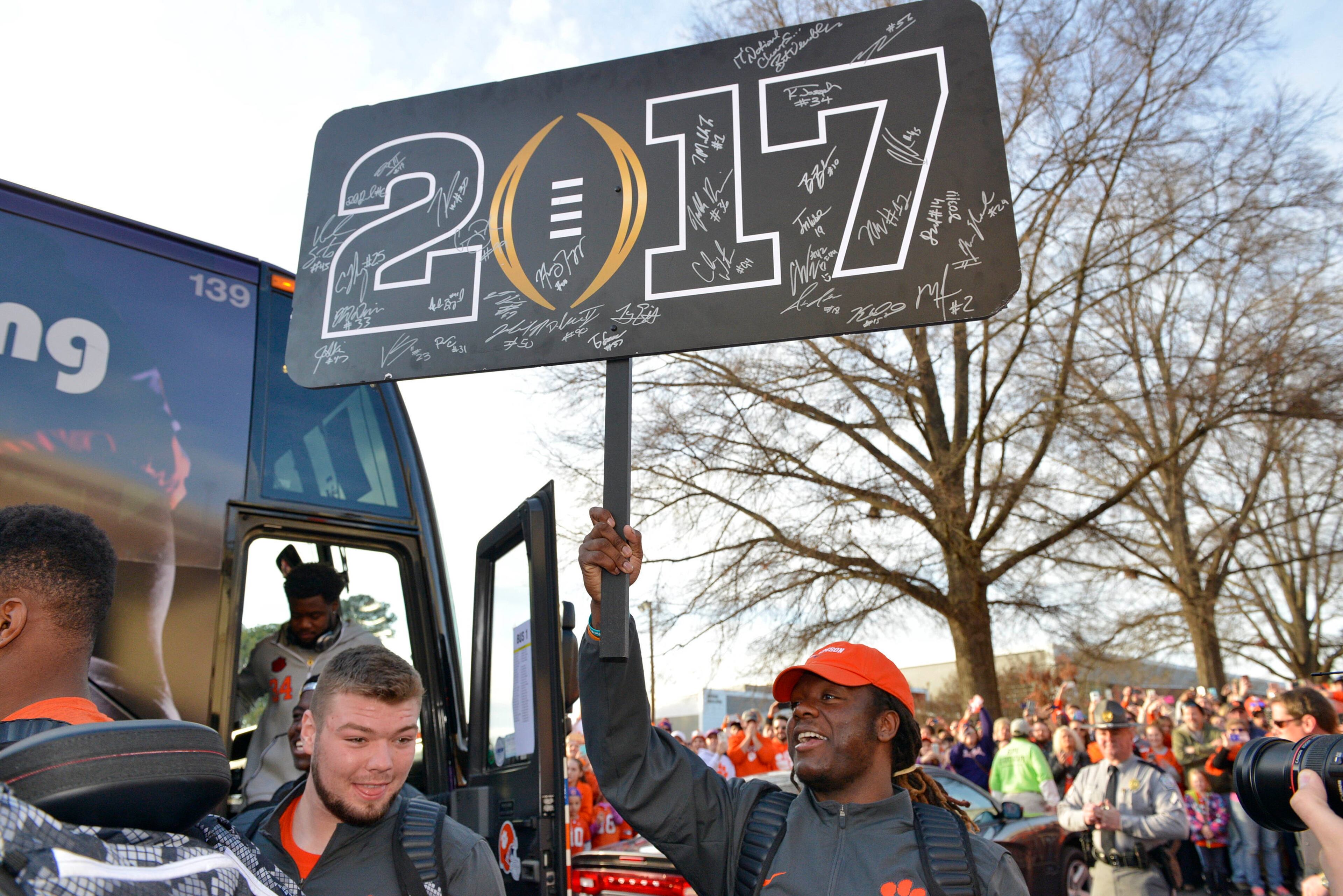 Clemson's Jalen Williams holds a sign as the team arrives, Tuesday, Jan. 10, 2017, in Clemson, S.C., the day after the Tigers defeated Alabama 35-31 in the College Football Playoff championship NCAA college football game in Tampa. (AP Photo/Richard Shiro)