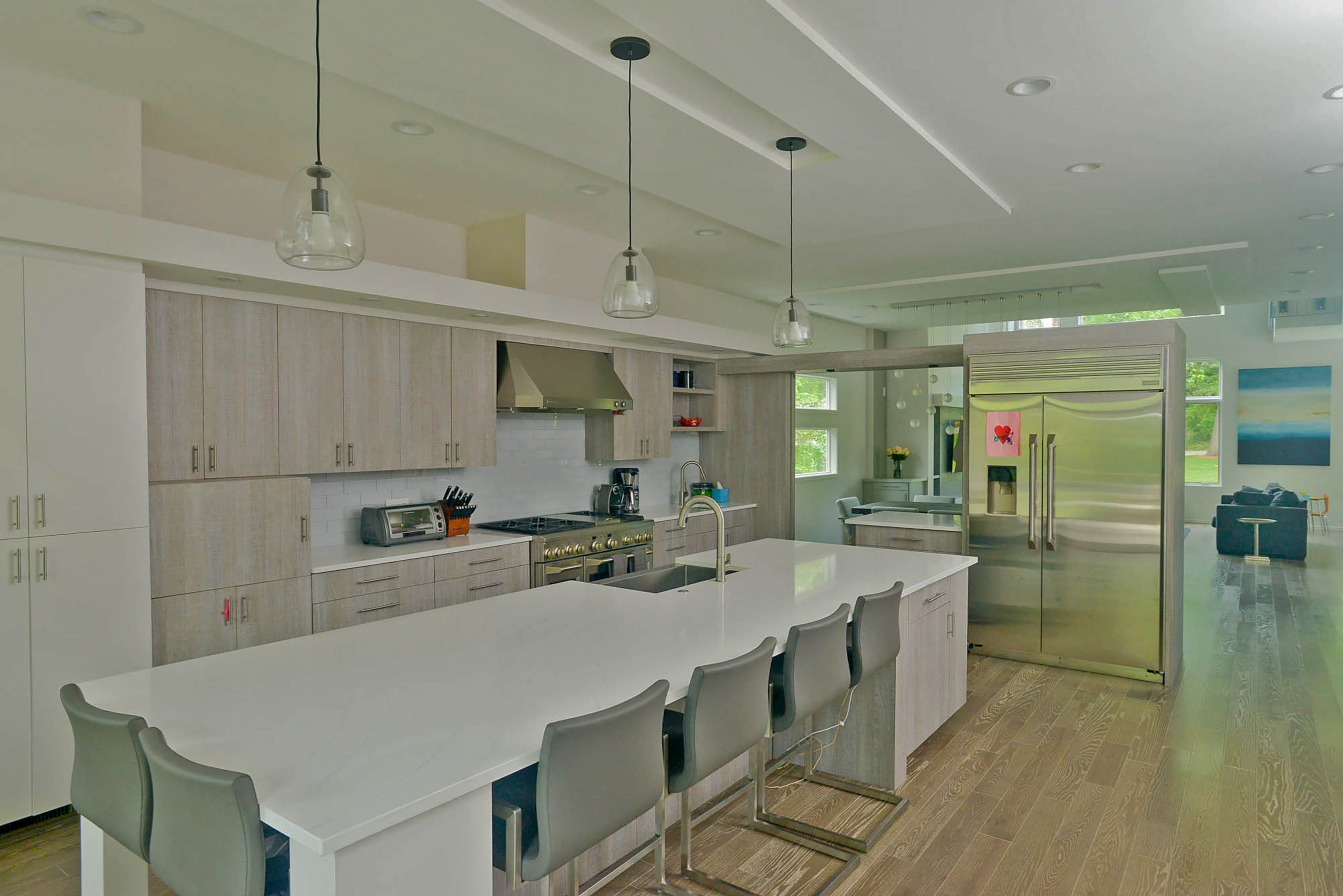 An extra-long island in the kitchen creates plenty of room for working, eating, playing and cooking.
