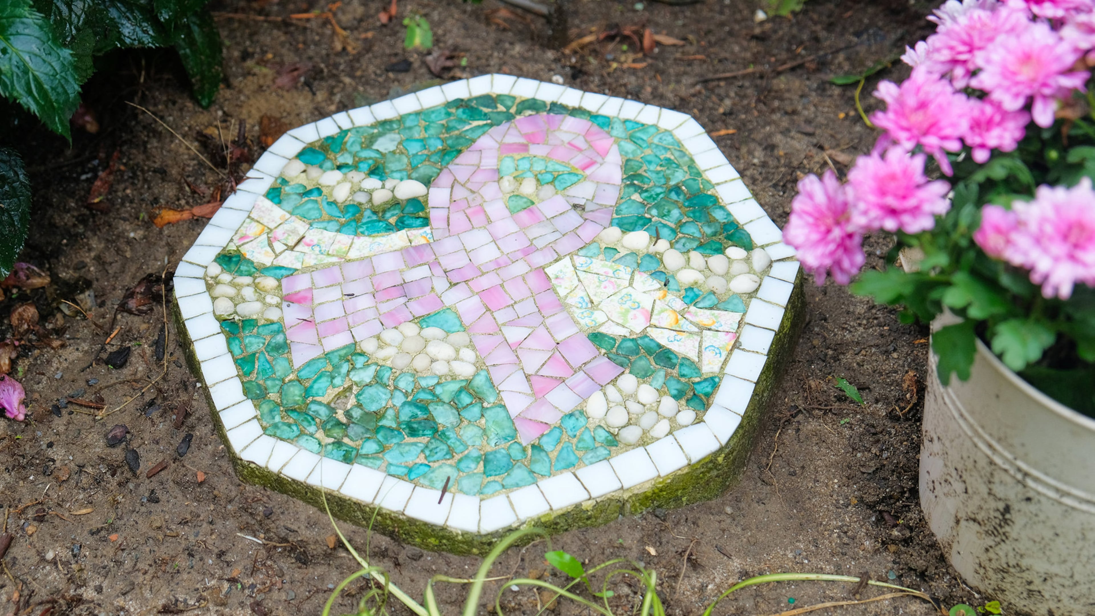 A breast cancer ribbon mosaic tile, handmade by Vera Capogna, a breast cancer survivor, decorates her pink themed garden. (Daniel Brennan)