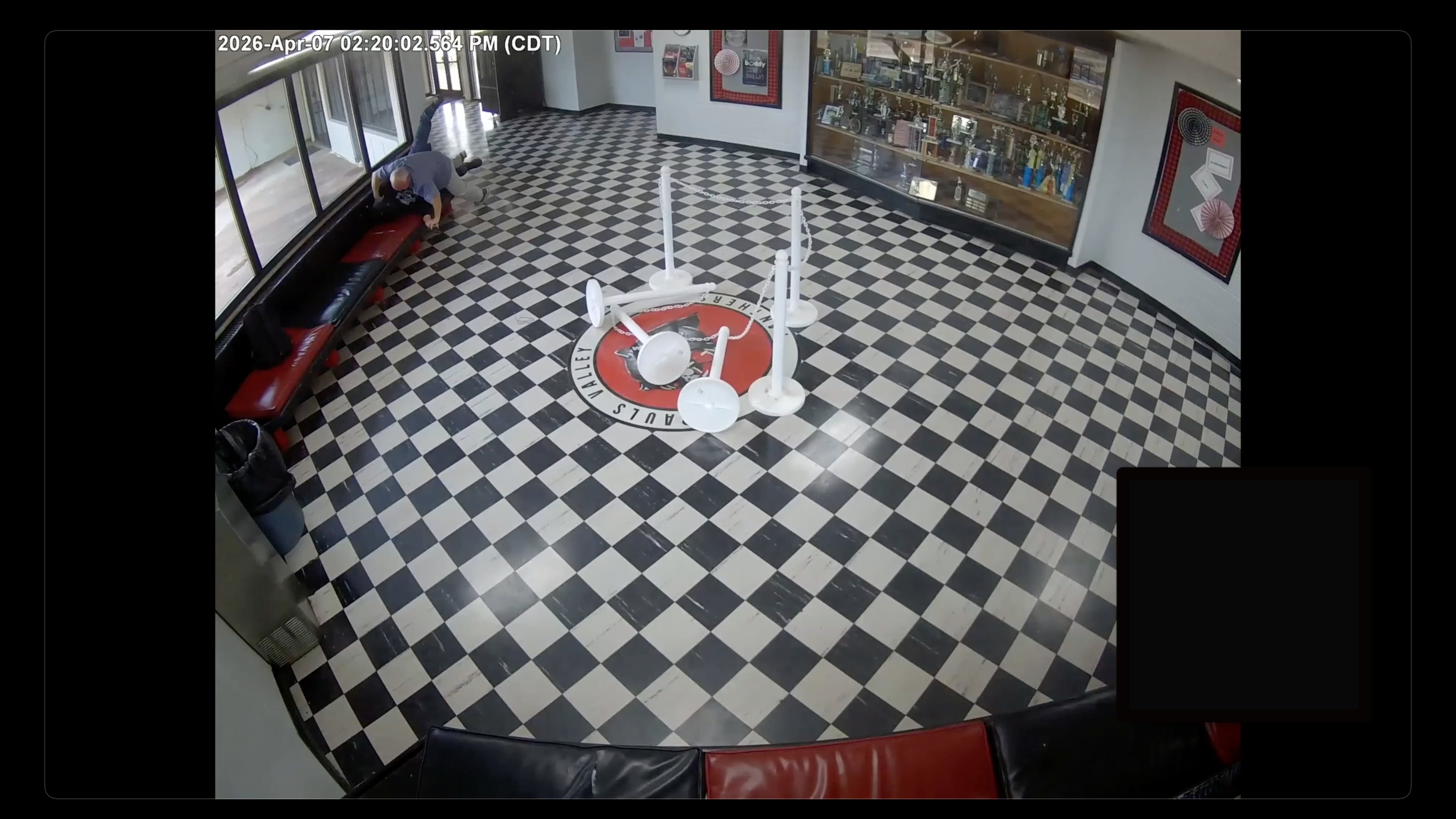 In this image taken from surveillance video released by Pauls Valley Public Schools, principal Kirk Moore can be seen struggling with Victor Hawkins, a former student who allegedly carried a firearm onto the campus on Tuesday, April 7, 2026 in Pauls Valley, Oklahoma. (Pauls Valley Public Schools via AP)