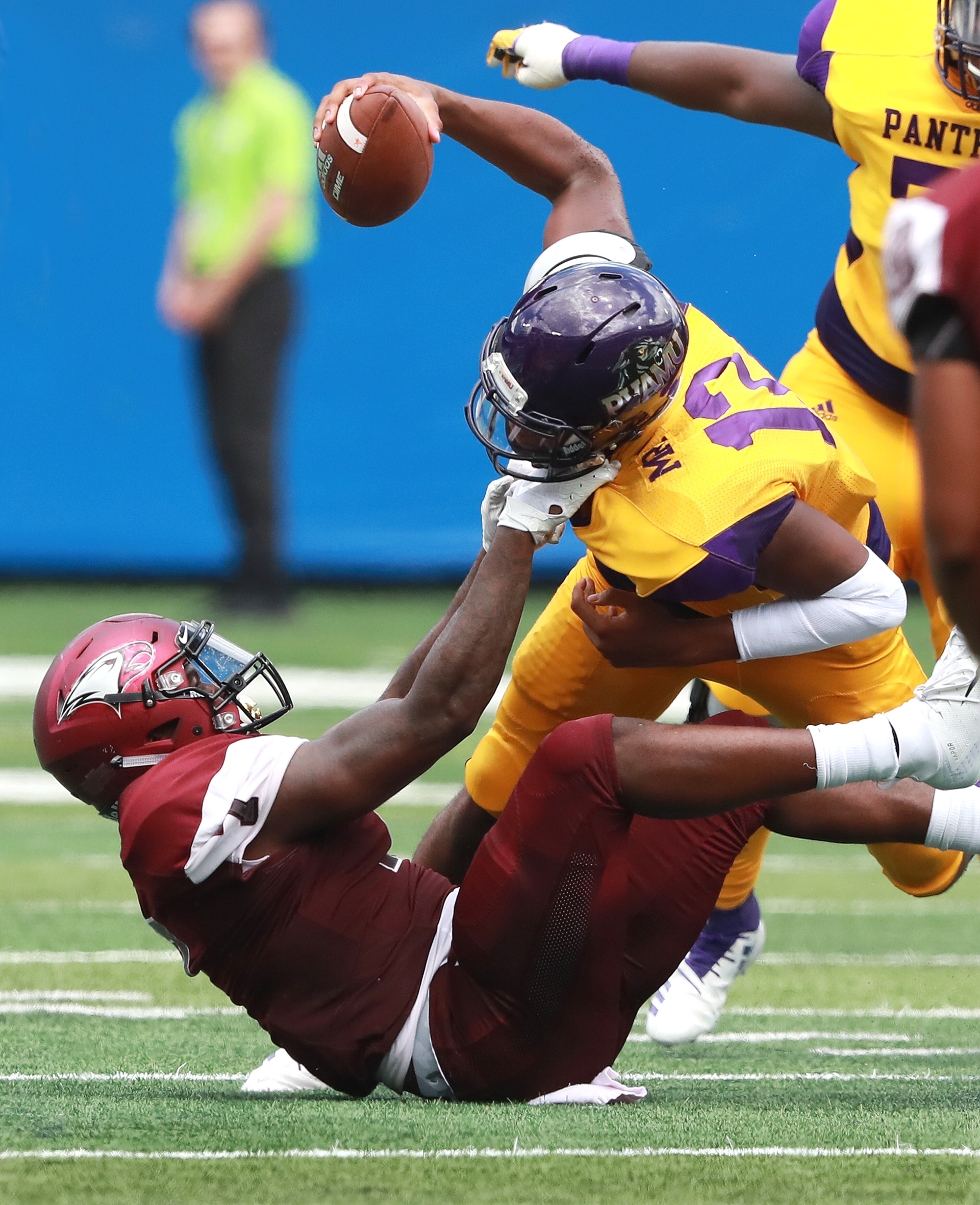 September 2, 2018 Atlanta: North Carolina Central defensive lineman Kawuan Cox grabs Prairie View A&M quarterback Jalen Morton by the facemask during the first half of the MEAC-SWAC Challenge college football game on Sunday, Sept 2, 2018, in Atlanta. Curtis Compton/ccompton@ajc.com