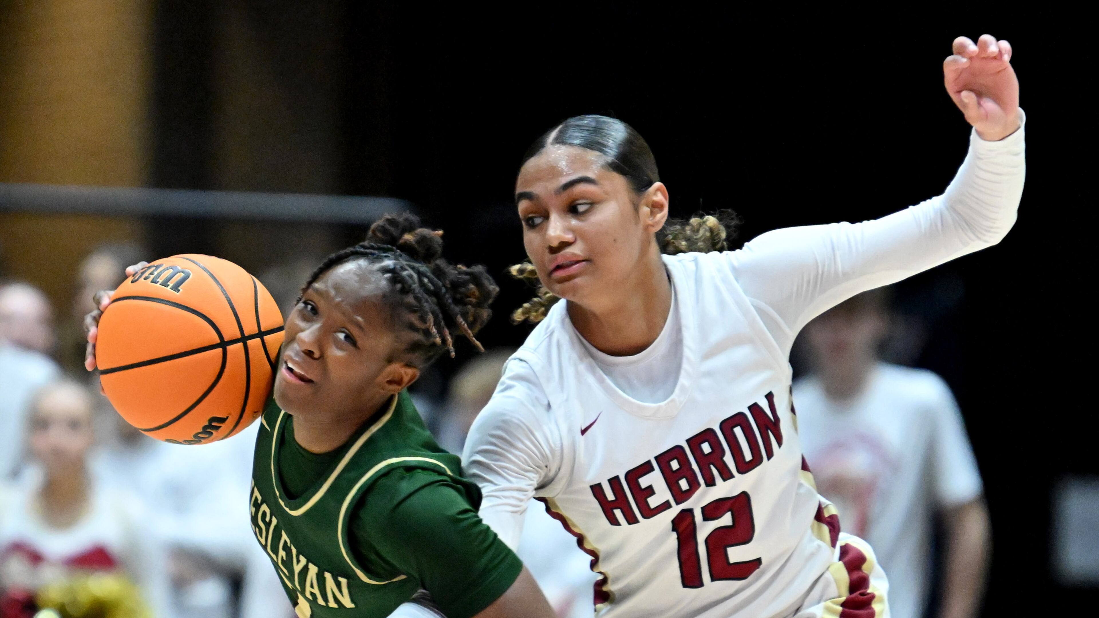 Wesleyan's Chazadi Wright (left) is fouled by Hebron Christian's Aubrey Beckham (12) during the second half of GHSA Basketball Class 3A Girl’s State Championship game at the Macon Centreplex, Friday, Mar. 8, 2024, in Macon. Hebron Christian won 62-60 over Wesleyan. (Hyosub Shin / Hyosub.Shin@ajc.com)