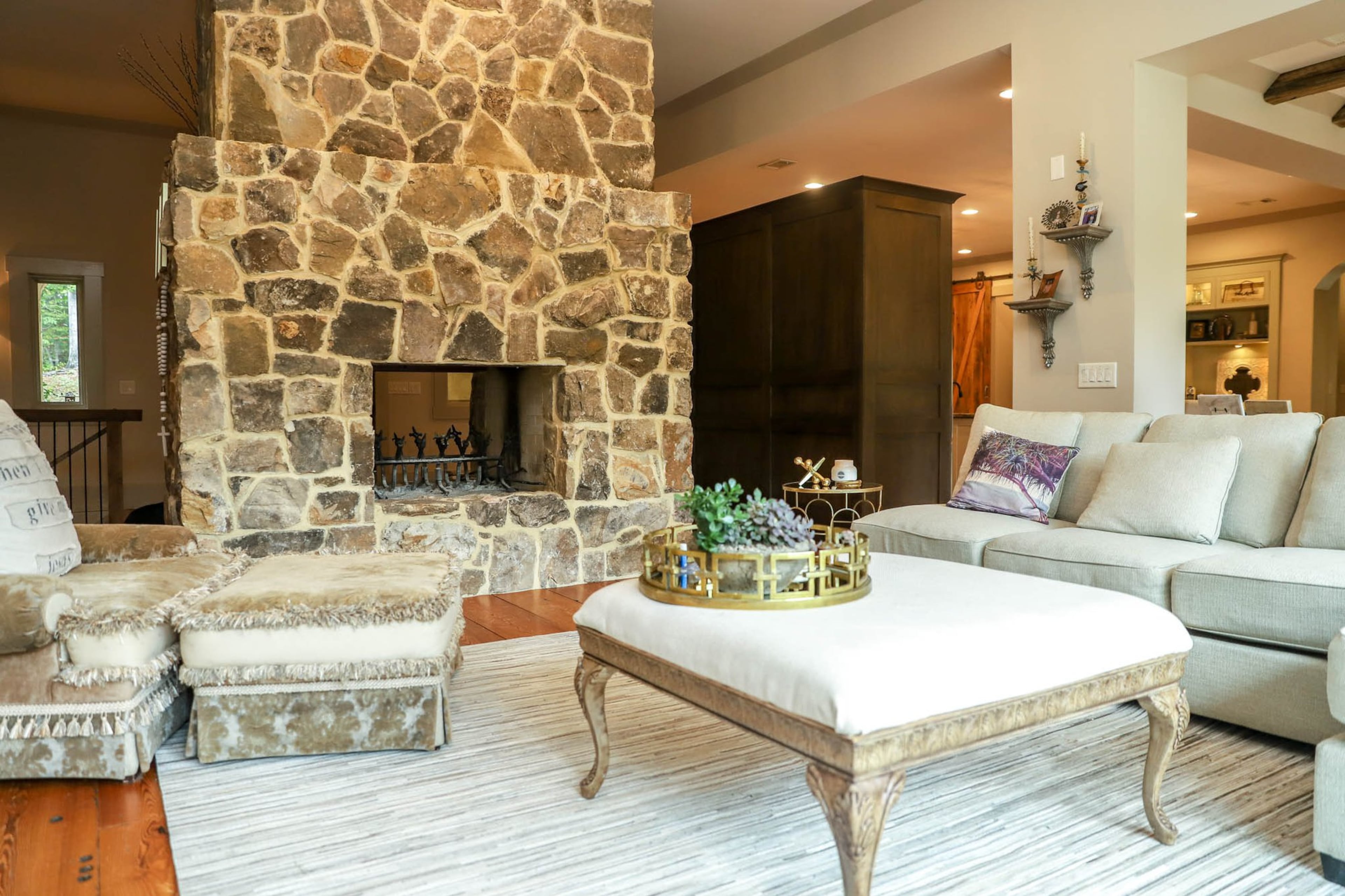 A multicolor rug from RH along with couches and a loveseat from Macy’s, creating a comfortable seating space in the family room of Jennifer and Michael Marblestone’s Acworth home. Their style is fresh and transitional with European influences. Text by Shannon Dominy. Photo by Reynolds Rogers.