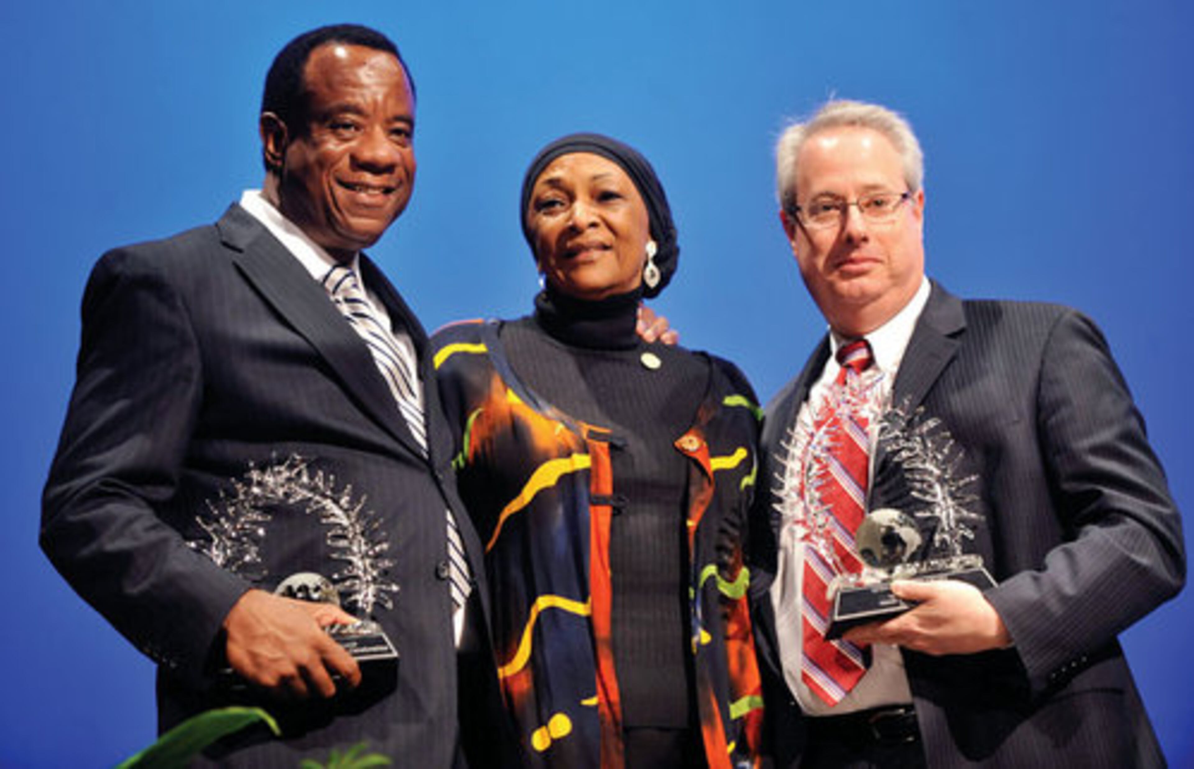 Cobb County NAACP president Deane Bonner (center) presents the Living the Dream Award to (from left) Lockheed Martin's Lee Rhyant and Georgia Attorney General Sam Olens.