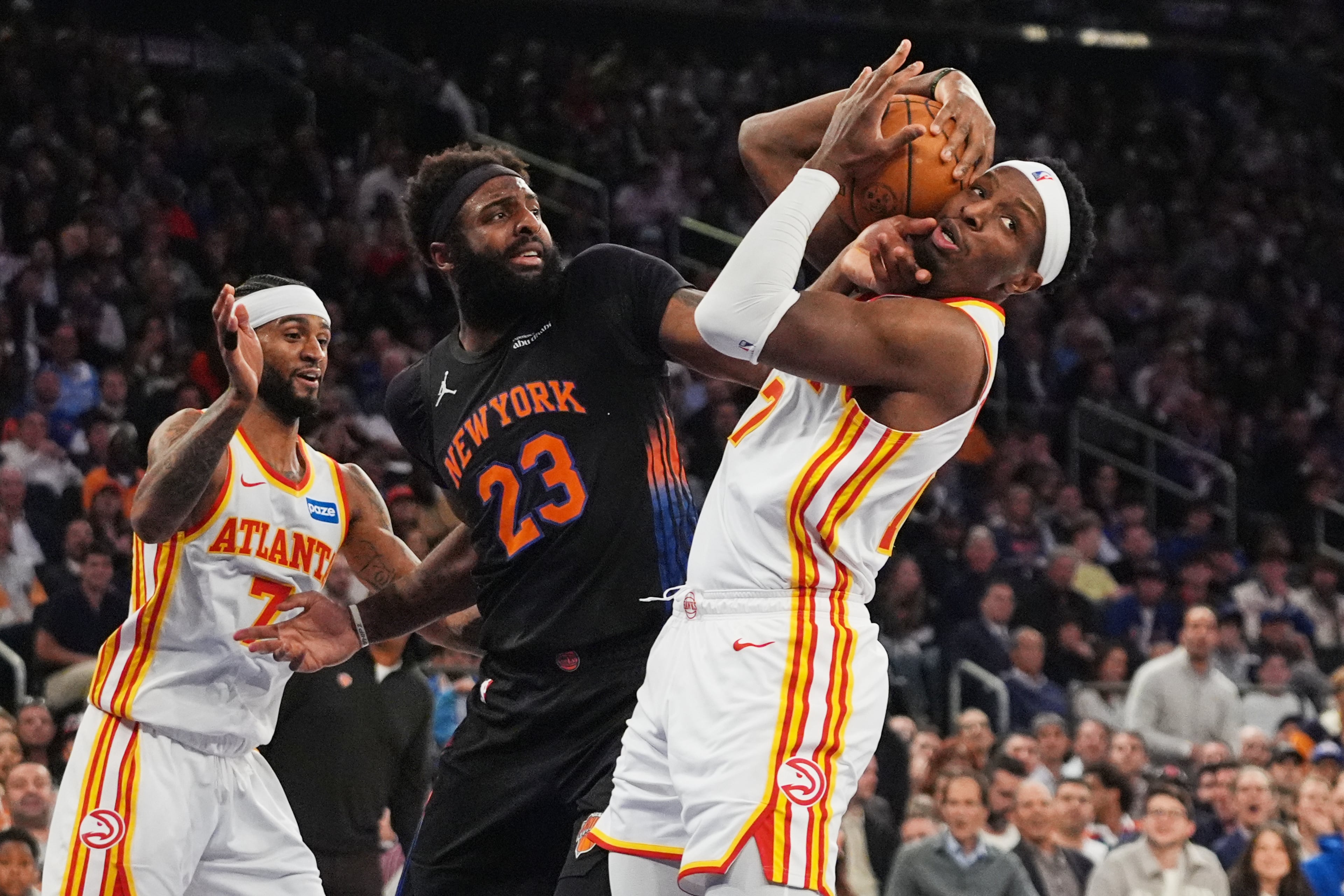 The Hawks' Nickeil Alexander-Walker (right) fights for control of the ball with the Knicks' Mitchell Robinson (center) during Game 5 of the first-round playoff series April 28, 2026, in New York. (Frank Franklin II/AP)